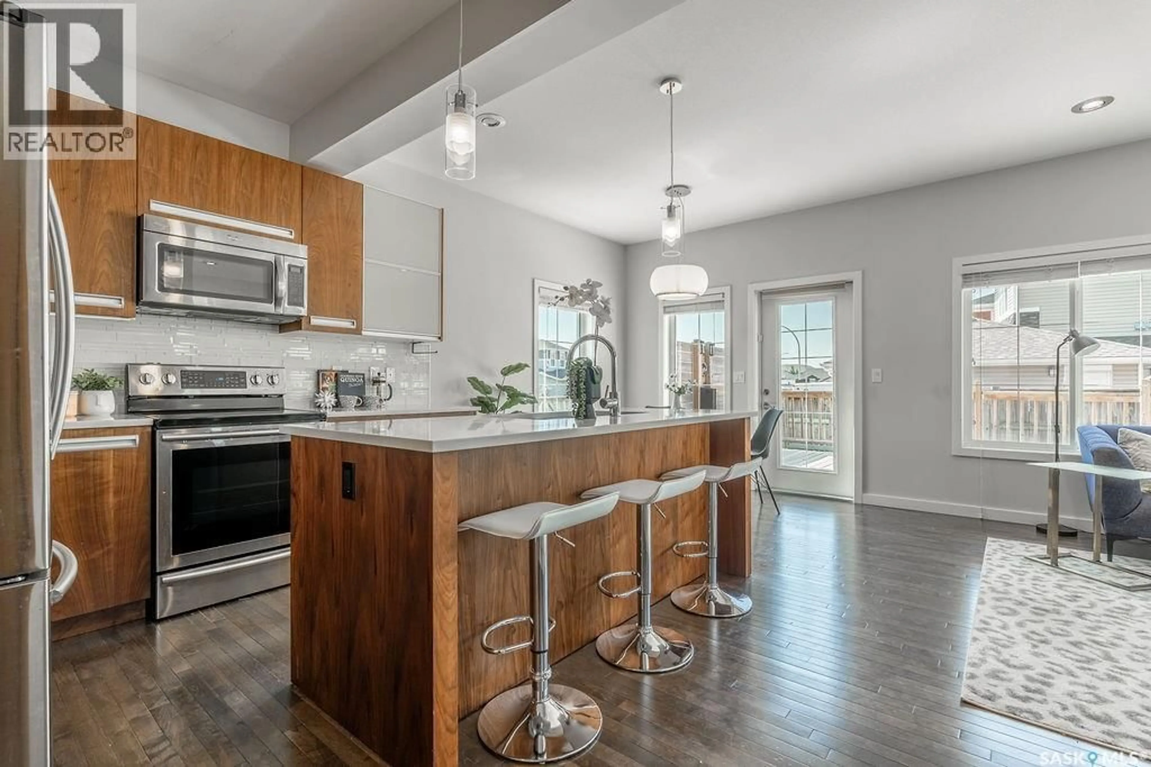 Open concept kitchen, wood/laminate floor for 603 PICHLER CRESCENT, Saskatoon Saskatchewan S7V0G2