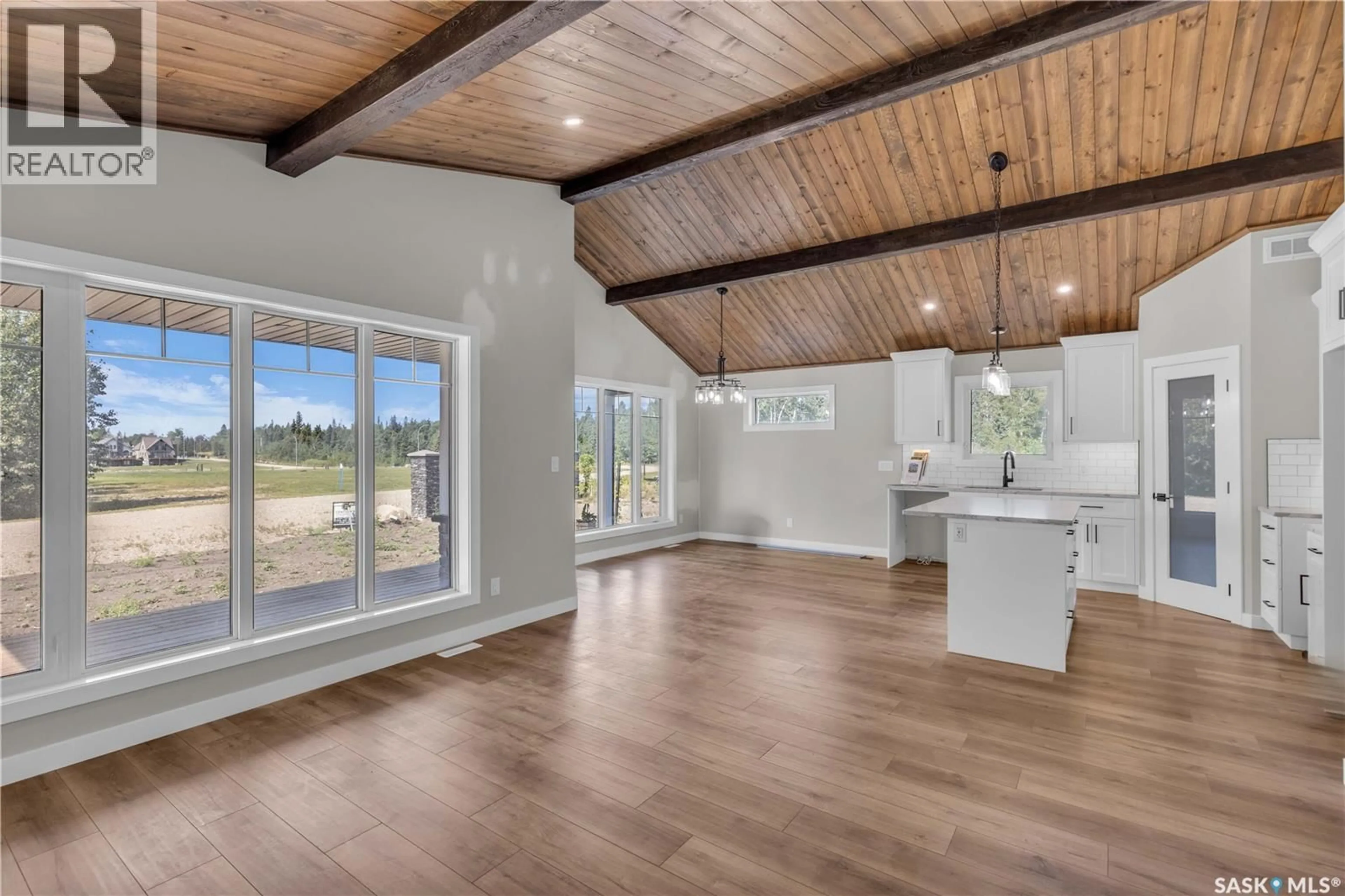 Open concept kitchen, wood/laminate floor for 101 - 23 NEIS ACCESS ROAD, Emma Lake Saskatchewan S0J0N0