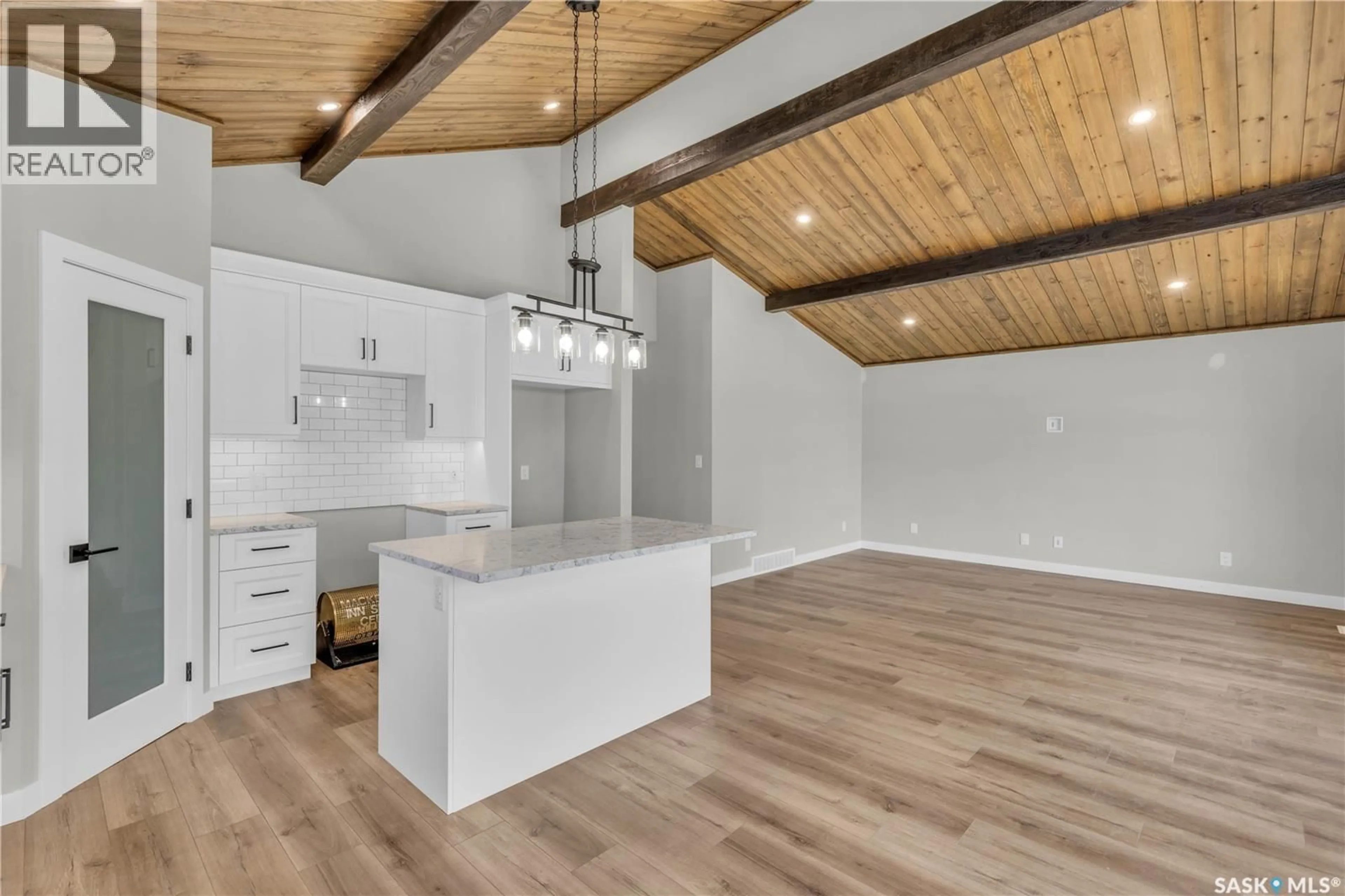 Open concept kitchen, wood/laminate floor for 101 - 23 NEIS ACCESS ROAD, Emma Lake Saskatchewan S0J0N0