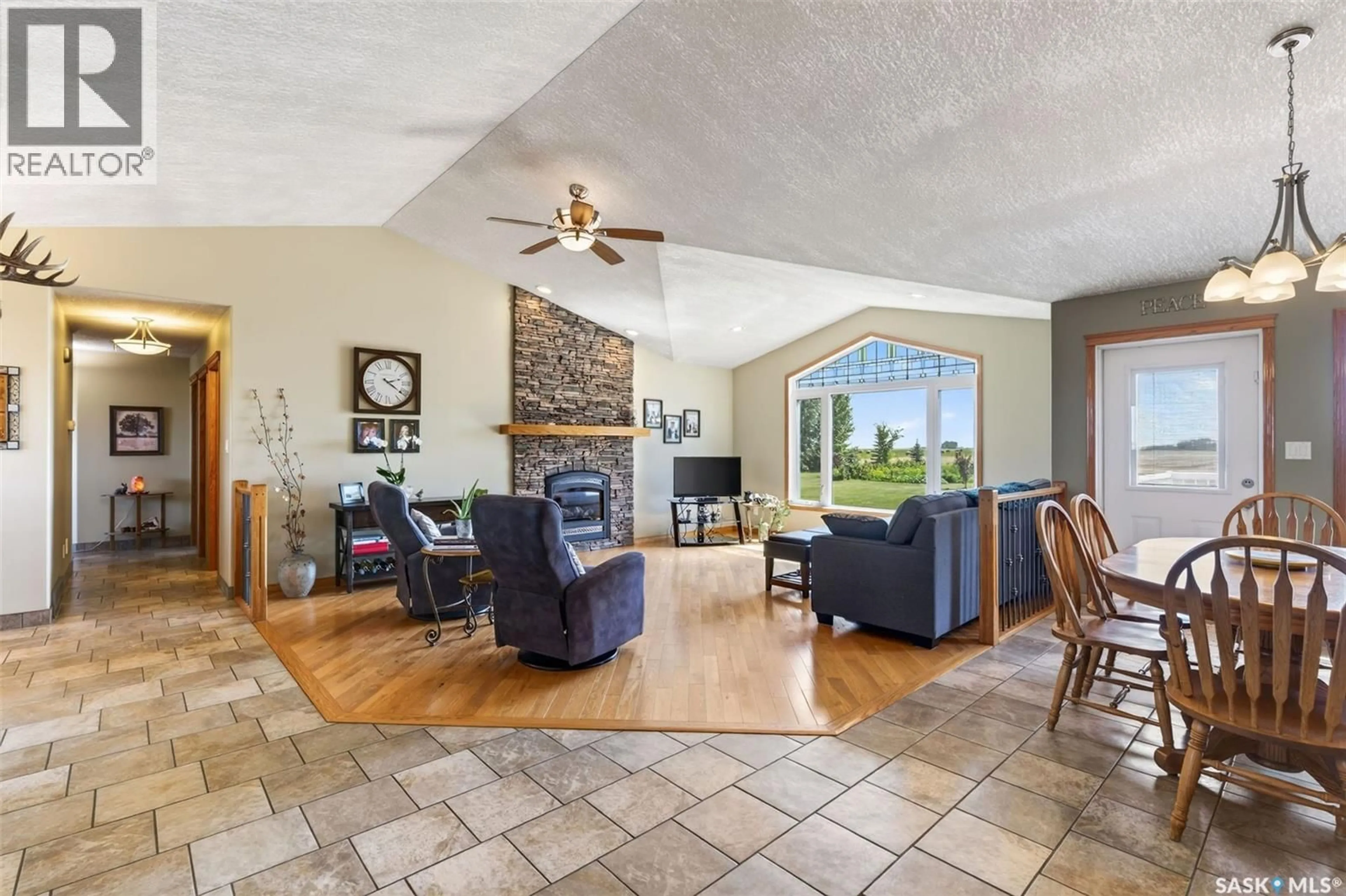 Living room with furniture, ceramic/tile floor for Acreage - PIKE LAKE RD, Vanscoy Rm No. 345 Saskatchewan S0L3J0
