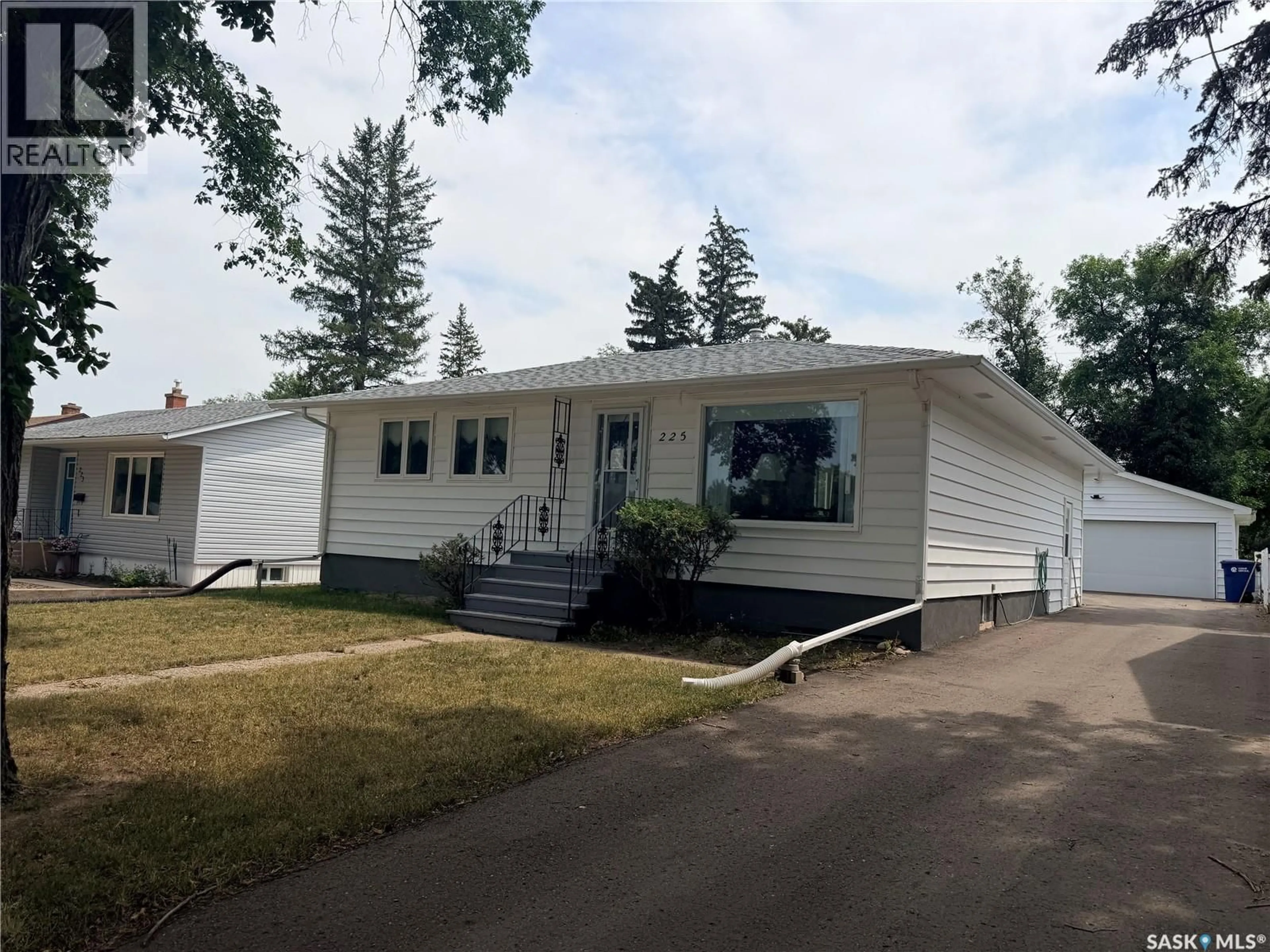 Home with vinyl exterior material, street for 225 DOMINION ROAD, Assiniboia Saskatchewan S0H0B0