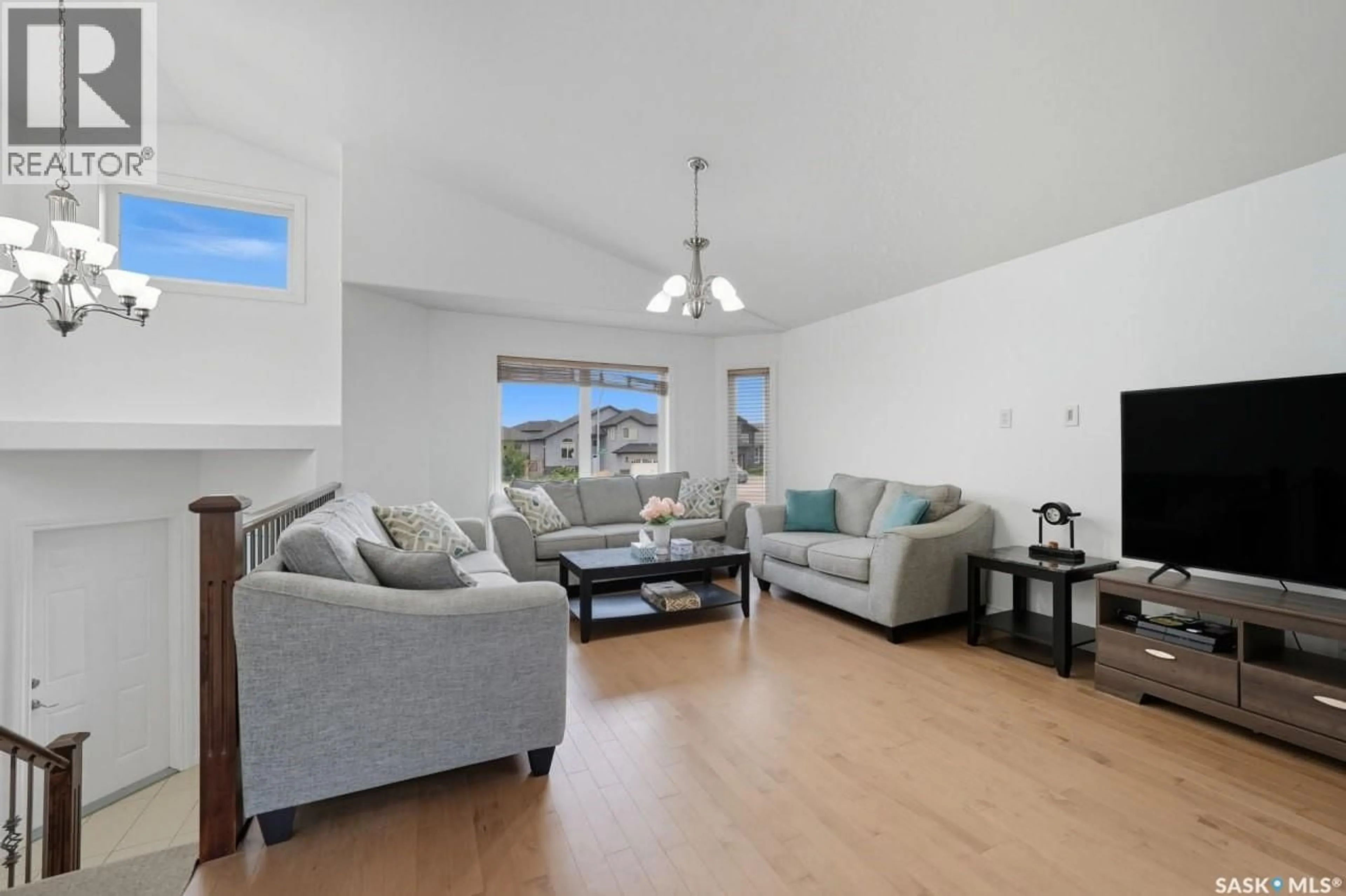 Living room with furniture, wood/laminate floor for 455 HASTINGS CRESCENT, Saskatoon Saskatchewan S7V0C8