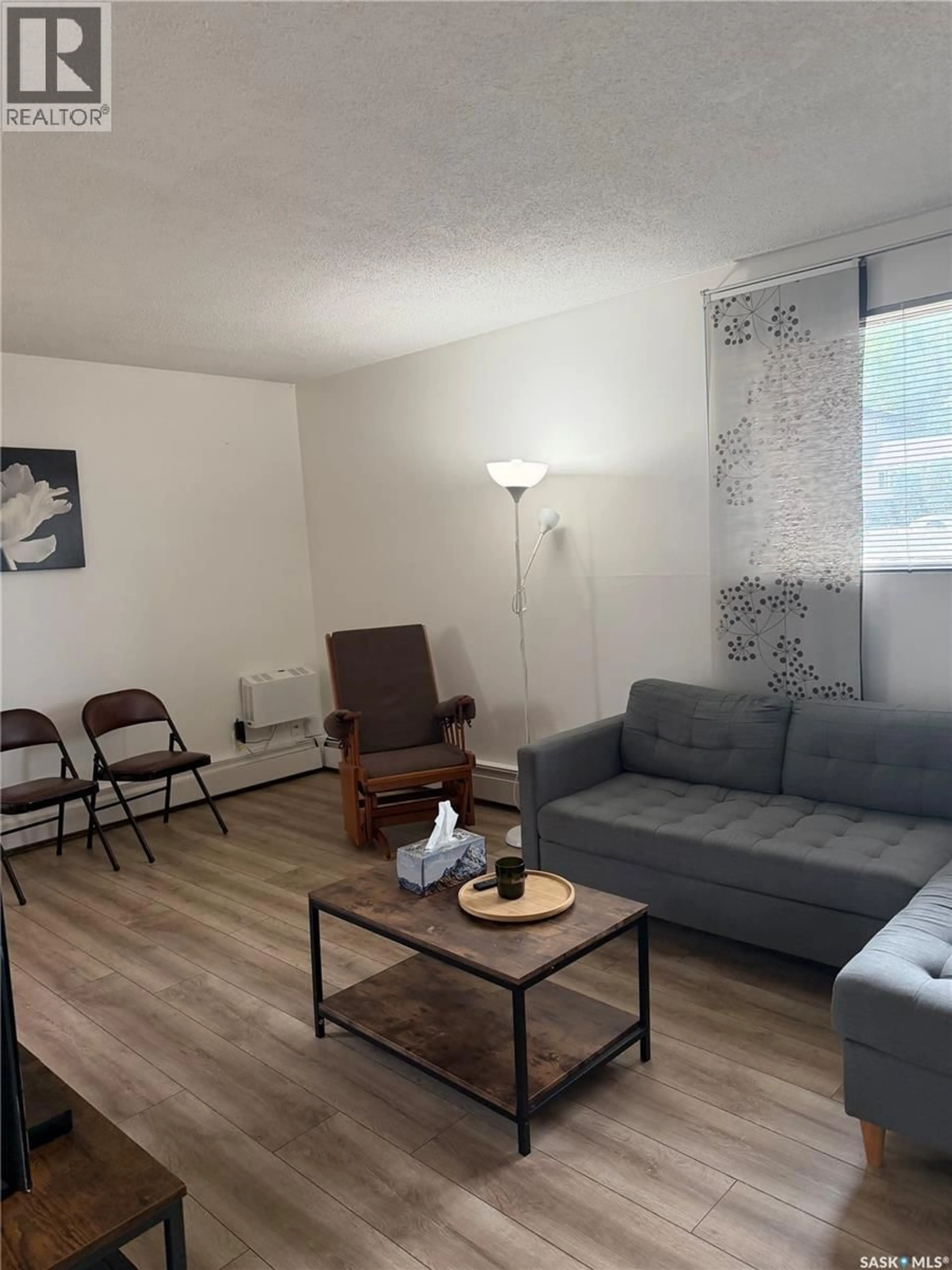 Living room with furniture, wood/laminate floor for 5 116 ACADIA COURT, Saskatoon Saskatchewan S7H4T7
