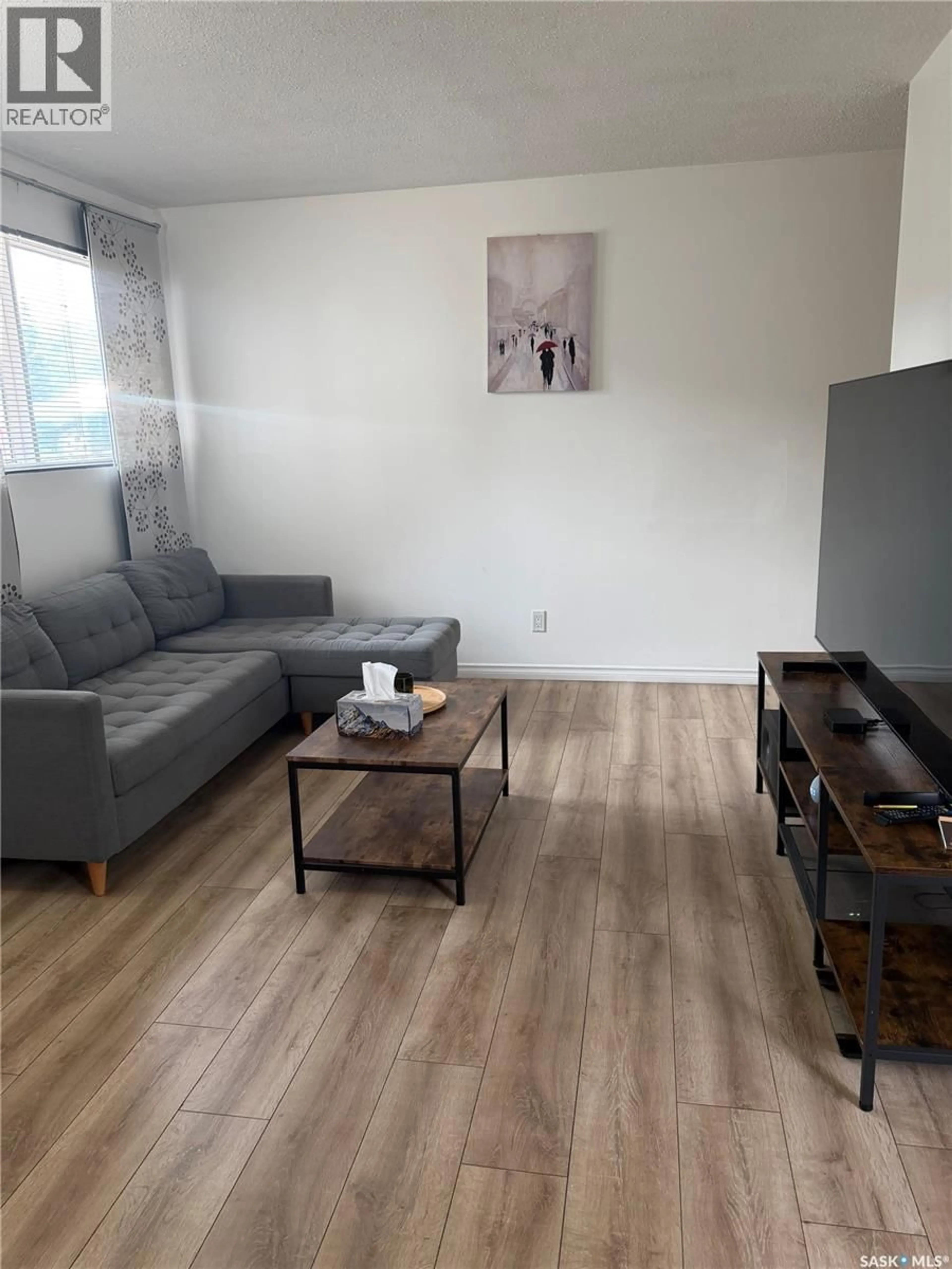 Living room with furniture, wood/laminate floor for 5 116 ACADIA COURT, Saskatoon Saskatchewan S7H4T7