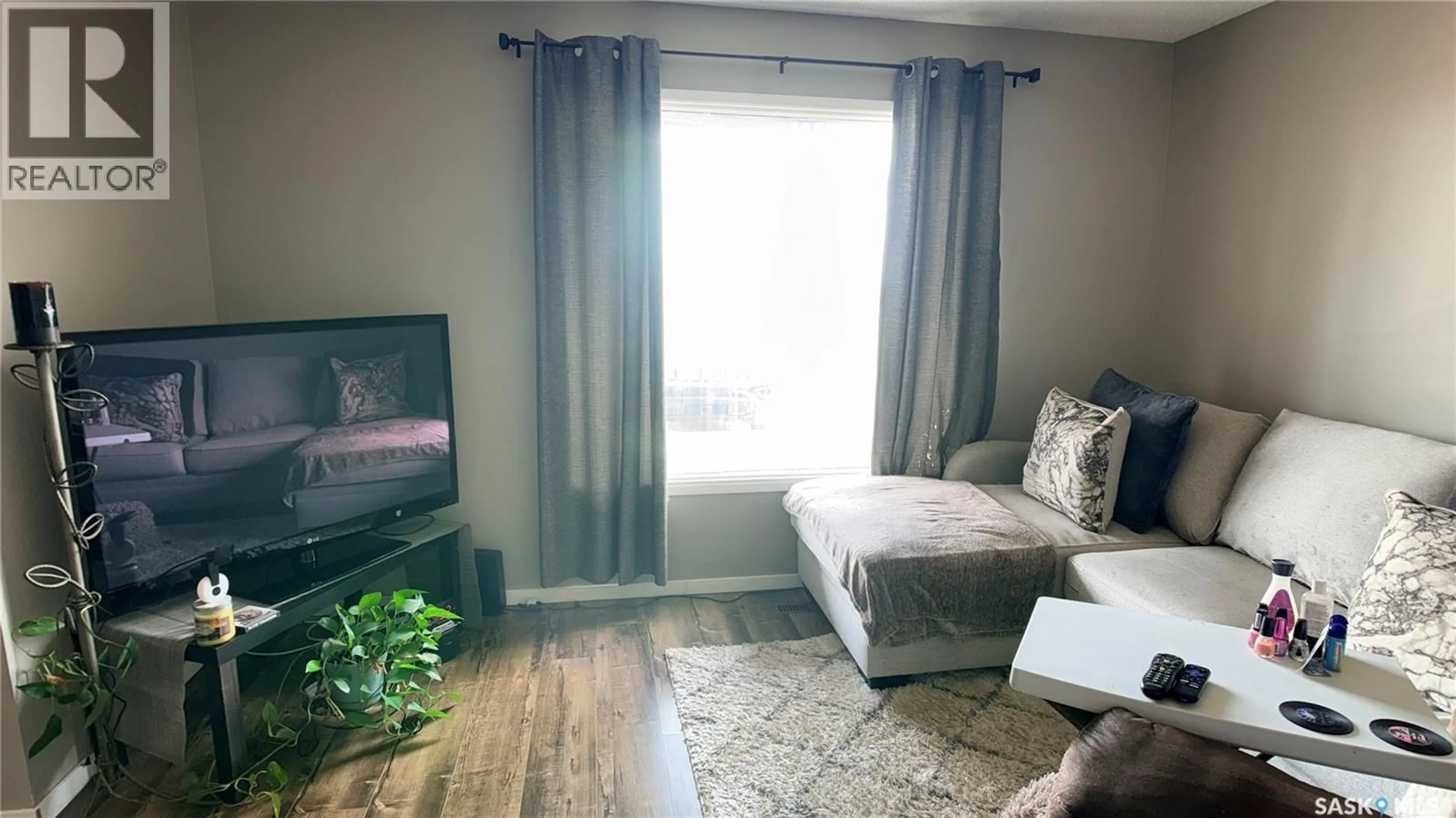 Living room with furniture, wood/laminate floor for 412 HERITAGE DRIVE, Estevan Saskatchewan S4A2N4