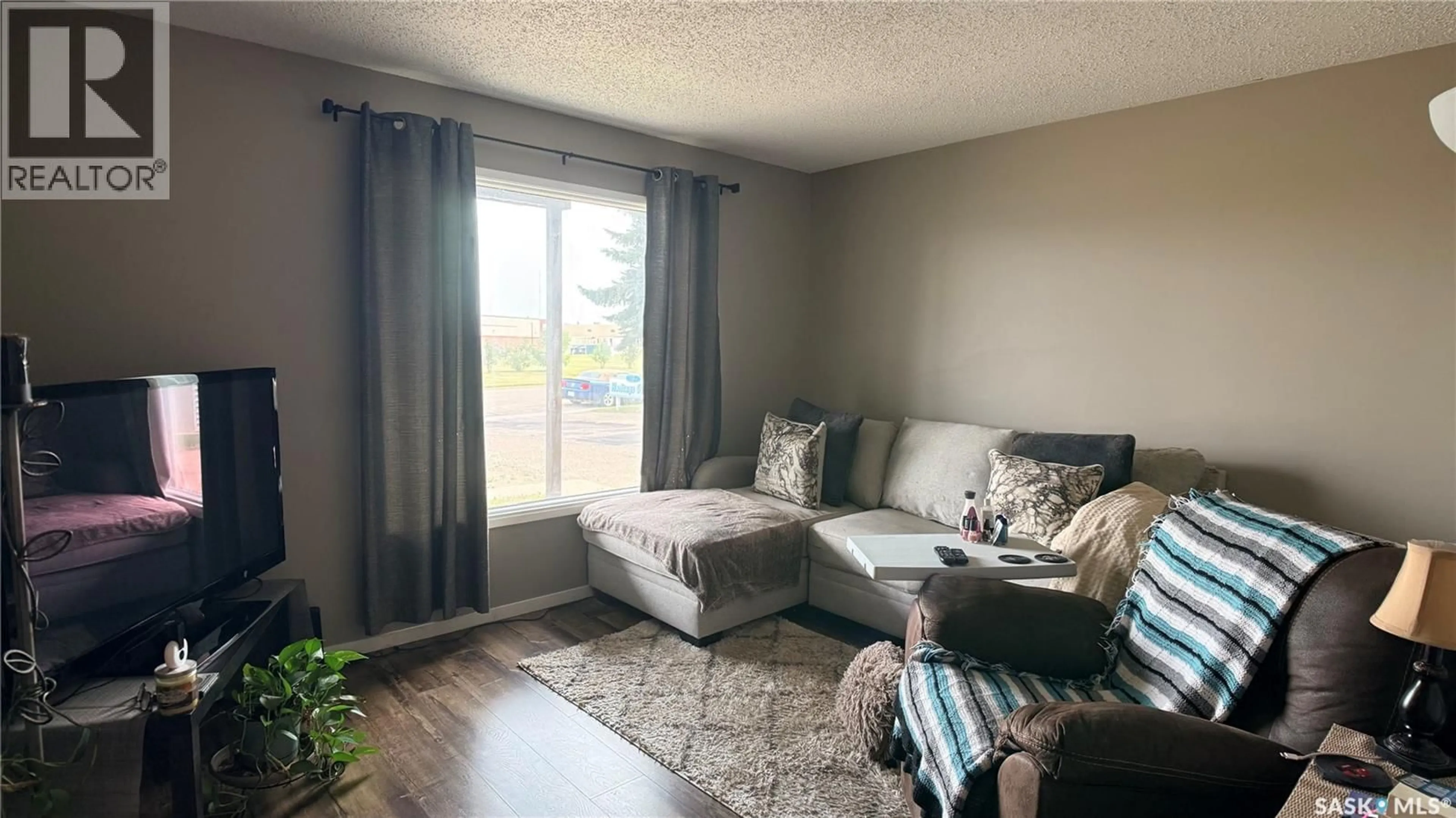Living room with furniture, wood/laminate floor for 412 HERITAGE DRIVE, Estevan Saskatchewan S4A2N4