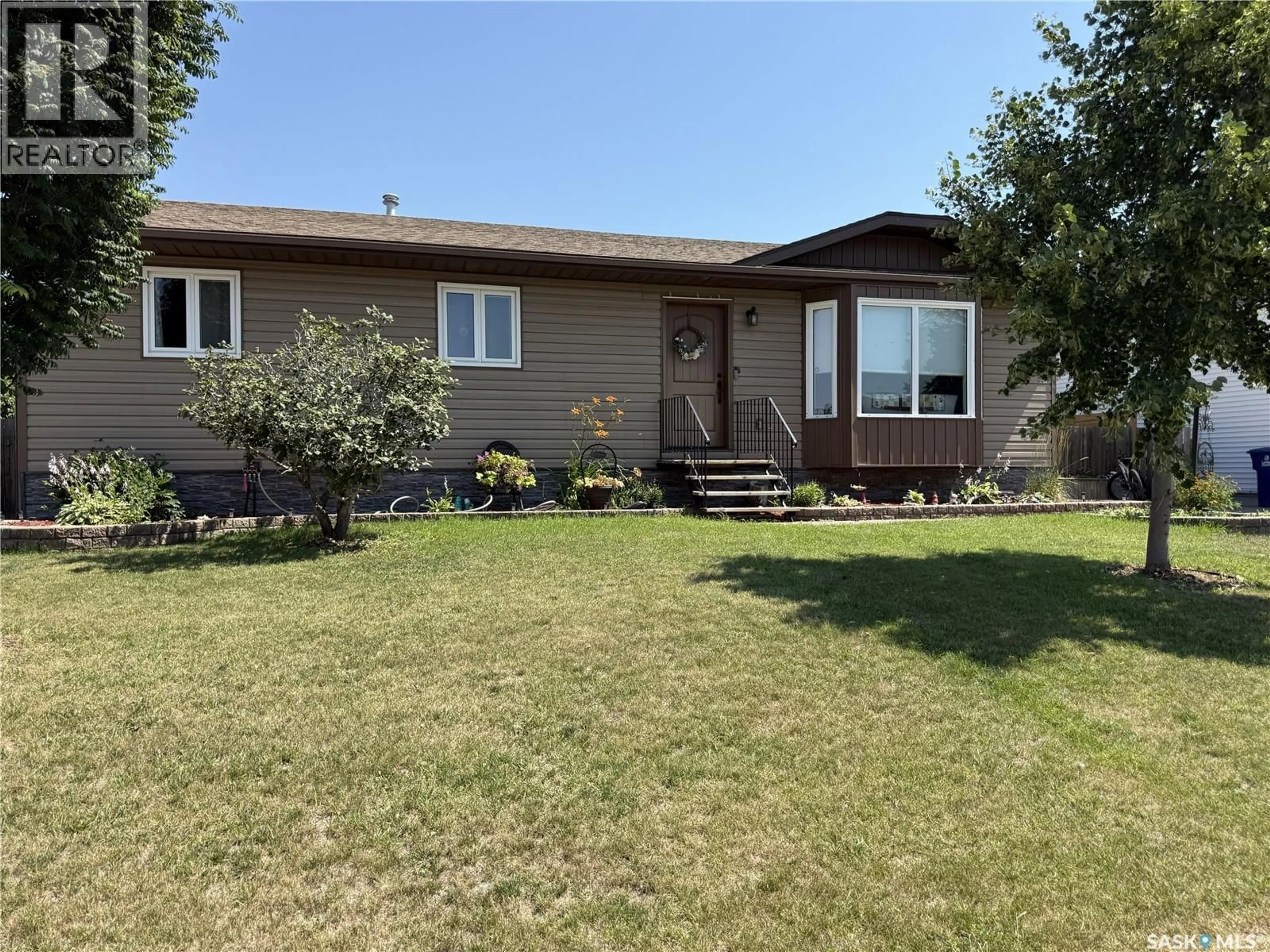 Home with vinyl exterior material, street for 207 MAPLE STREET, Outlook Saskatchewan S0L2N0