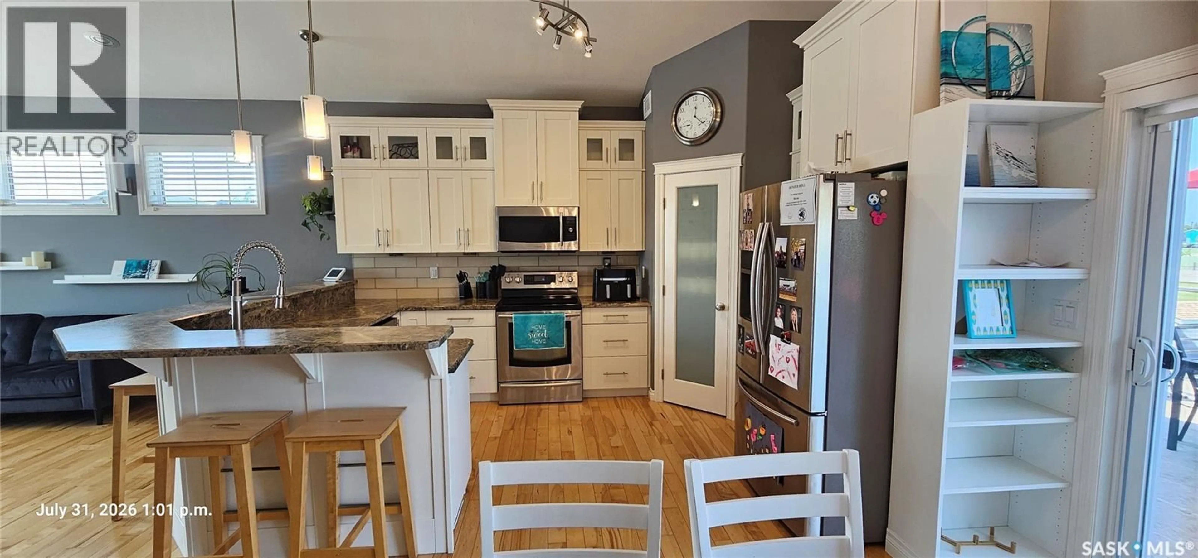 Open concept kitchen, wood/laminate floor for 128 KINSMEN CRESCENT, Martensville Saskatchewan S0K0A2