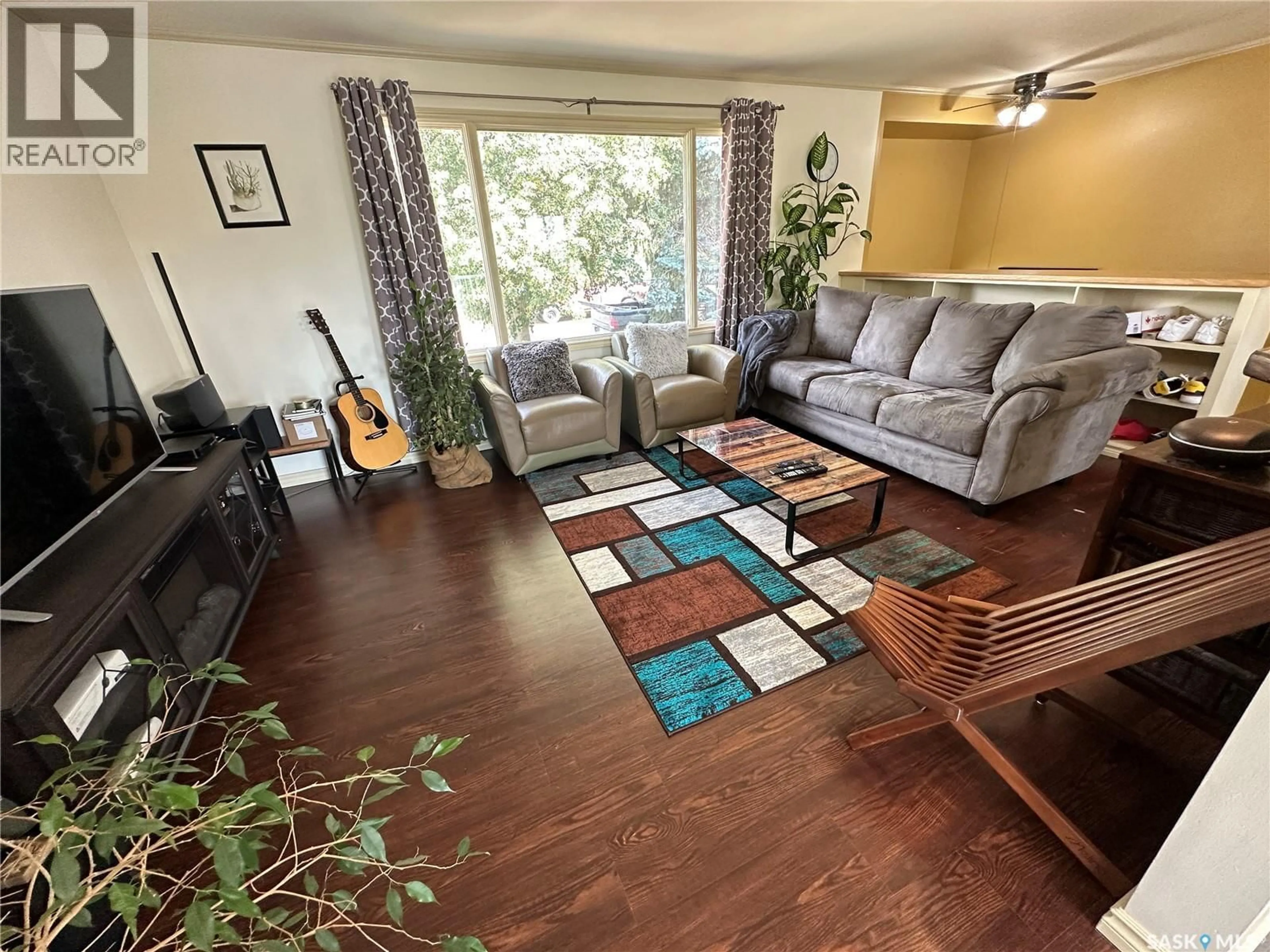 Living room with furniture, wood/laminate floor for 9005 5TH STREET, Rosthern Saskatchewan S0K3R0