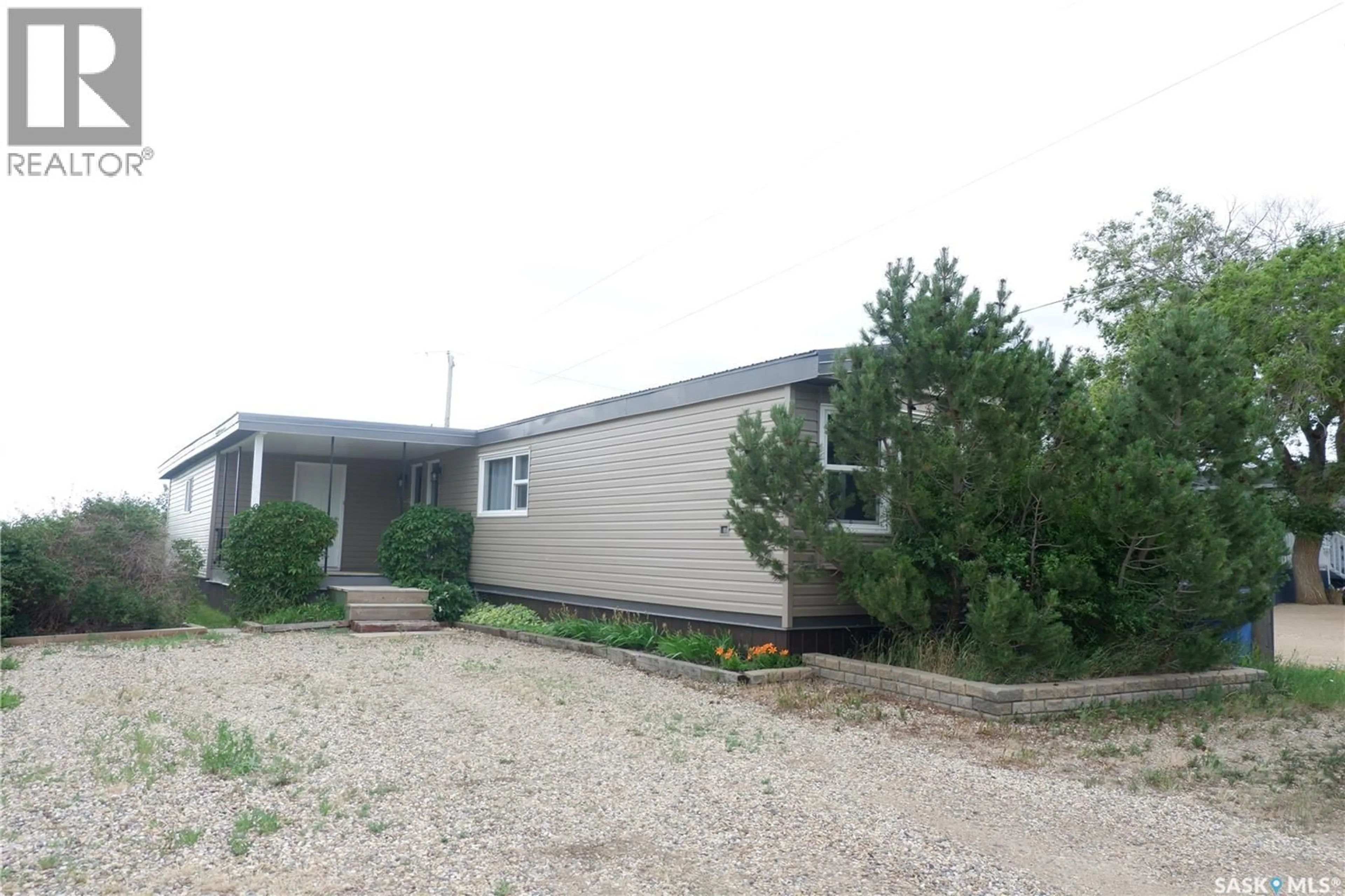 Home with vinyl exterior material, street for 67 SUNRISE ESTATES, Assiniboia Saskatchewan S0H0B0
