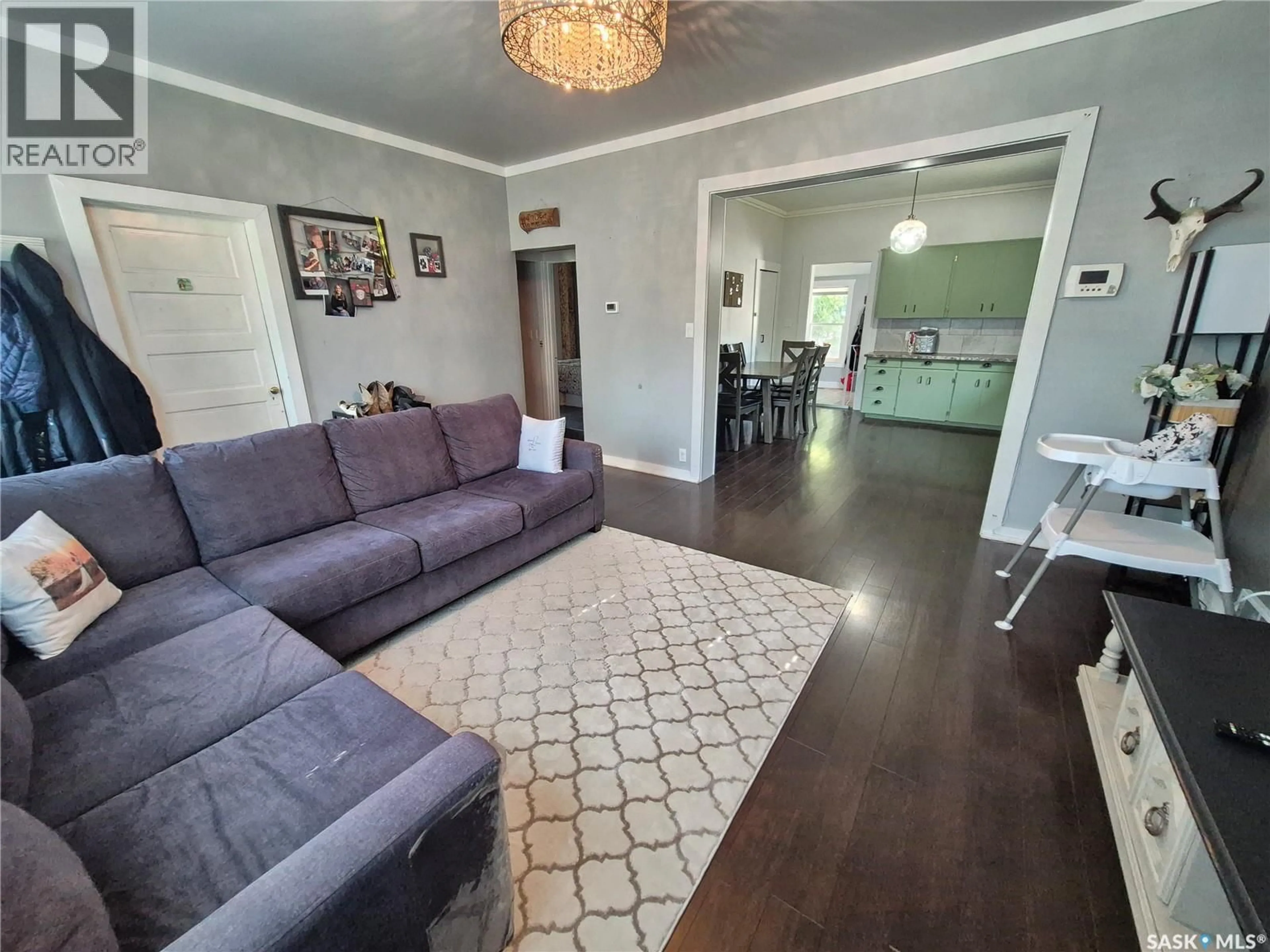 Living room with furniture, wood/laminate floor for 729 BERTRAND AVENUE, Radville Saskatchewan S0C2G0