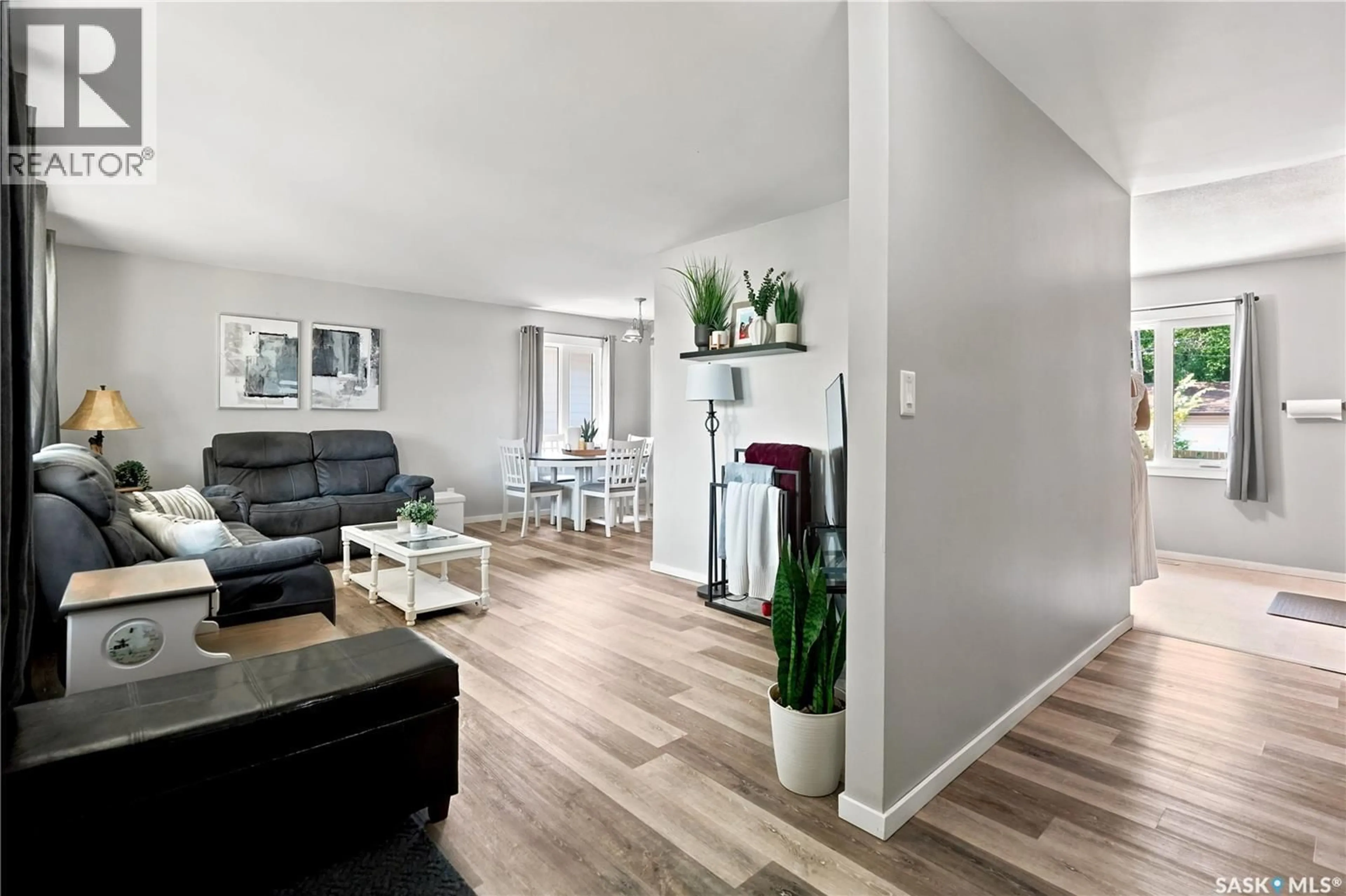 Living room with furniture, wood/laminate floor for 2816 QUEEN STREET, Regina Saskatchewan S4S2E4
