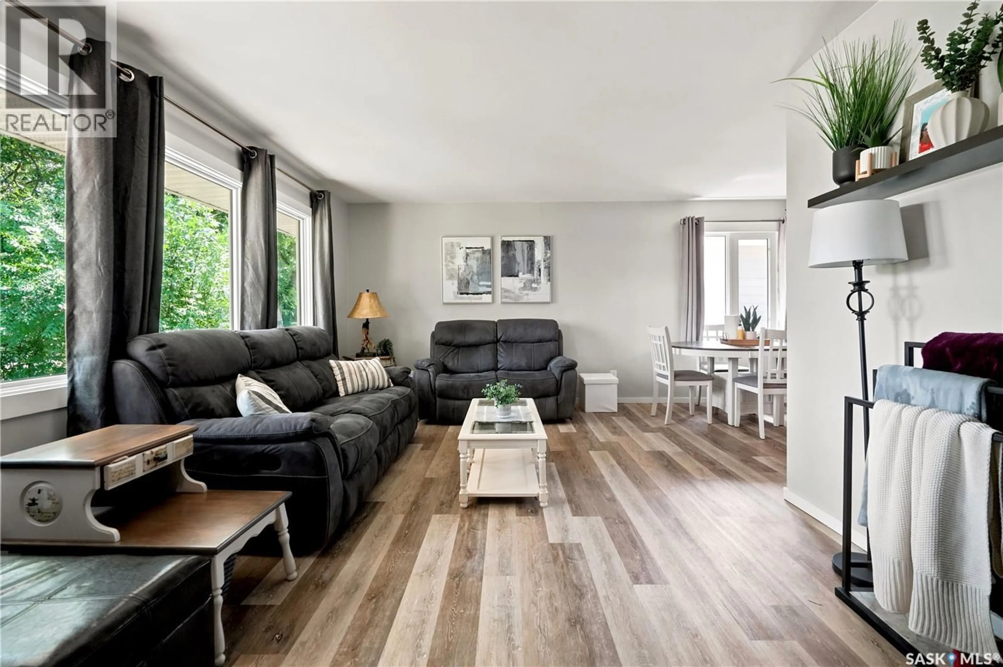 Living room with furniture, wood/laminate floor for 2816 QUEEN STREET, Regina Saskatchewan S4S2E4
