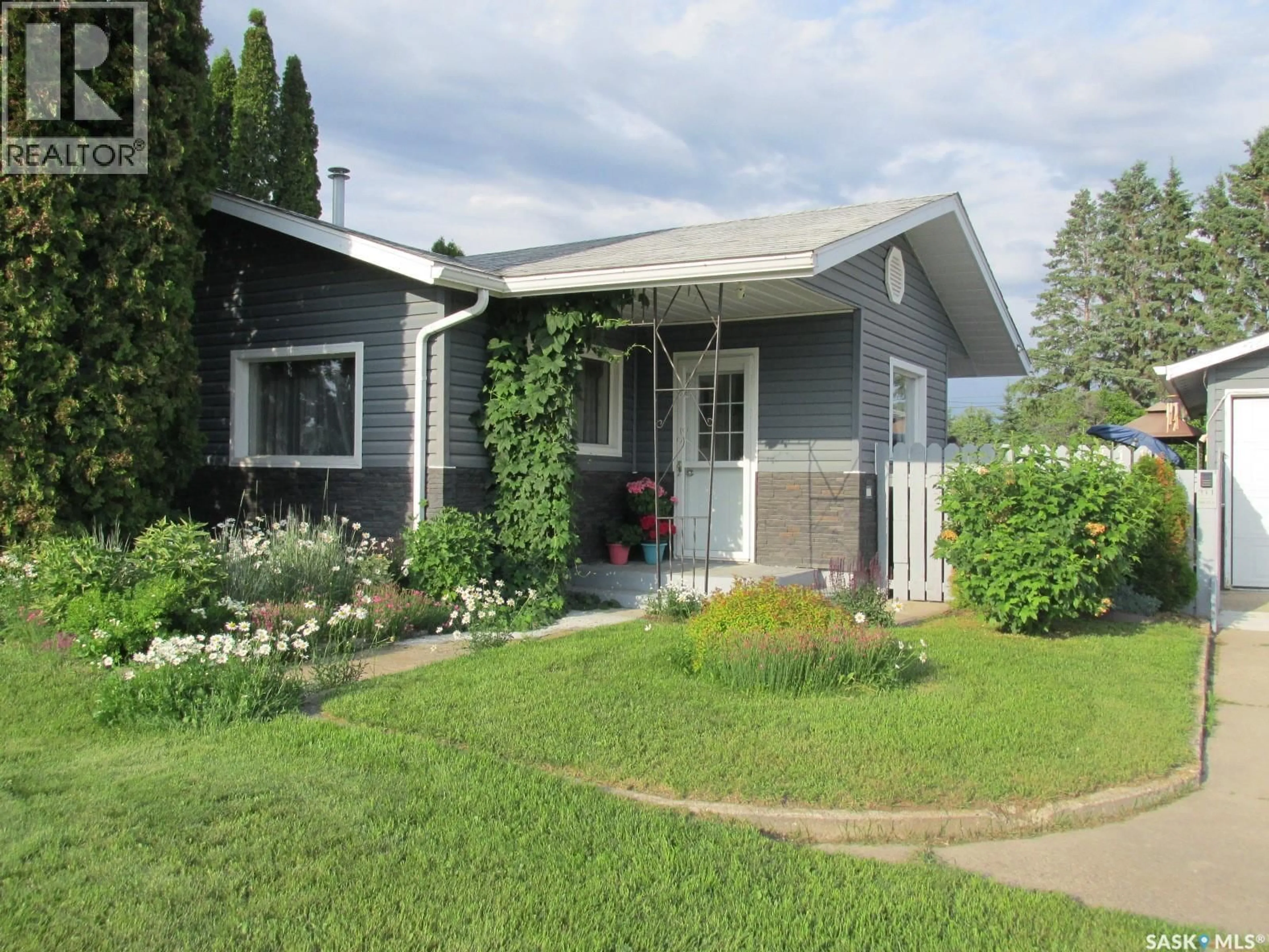 Home with vinyl exterior material, street for 311 3RD STREET, Nipawin Saskatchewan S0E1E0