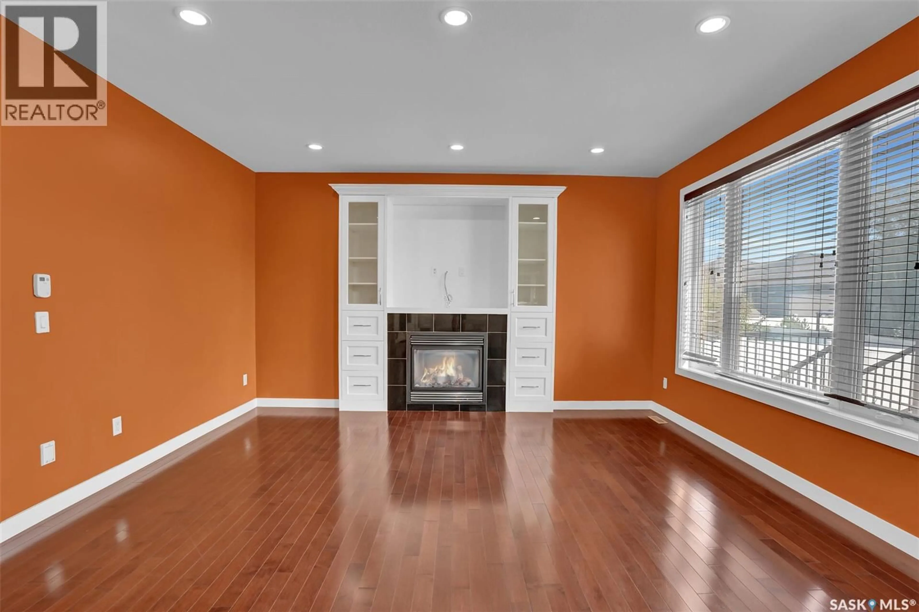 Living room with furniture, wood/laminate floor for 6033 LITTLE PINE LOOP, Regina Saskatchewan S4X0H5