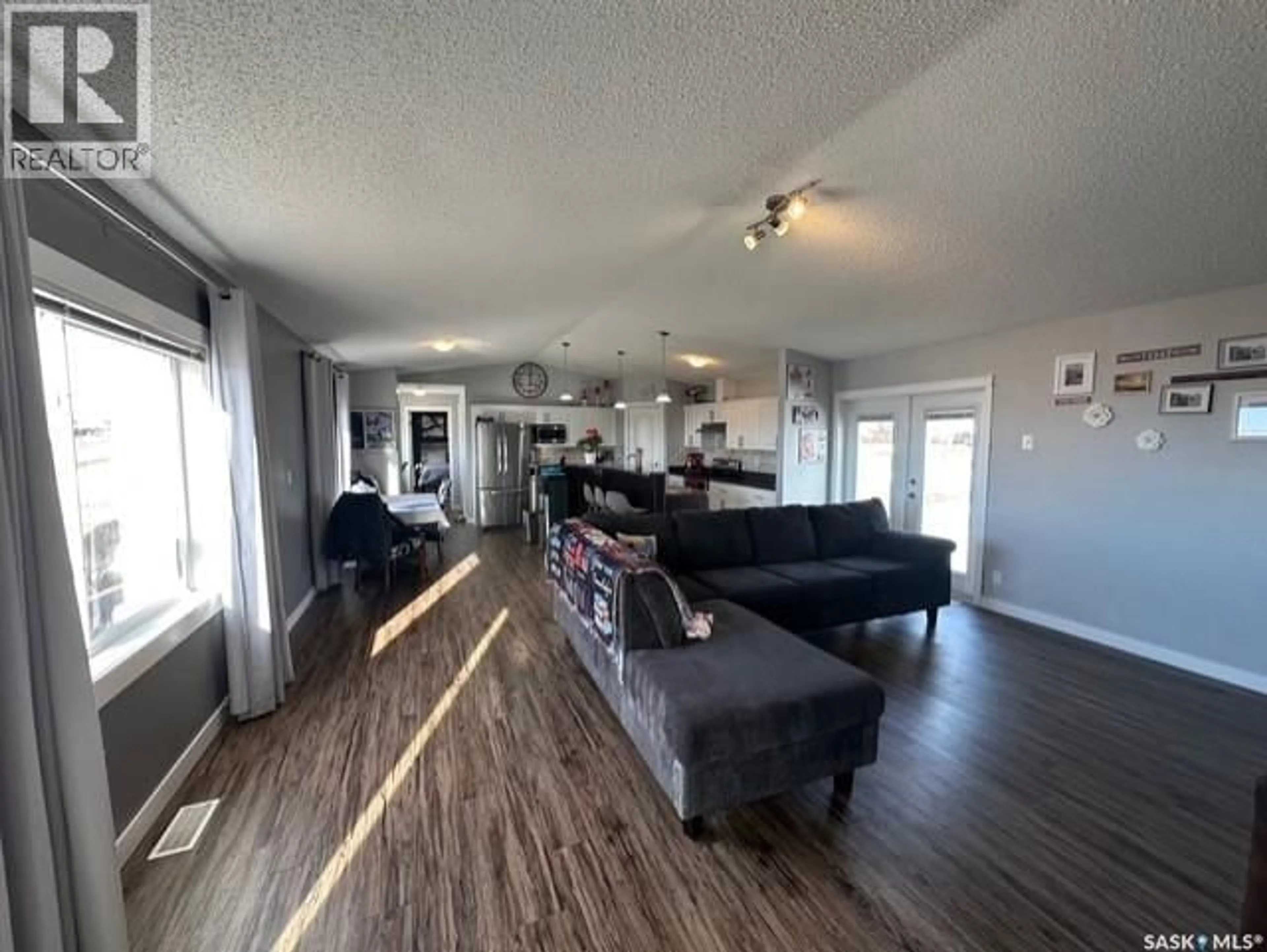 Living room with furniture, wood/laminate floor for VERWOOD, Excel Rm No. 71 Saskatchewan S0H4G0