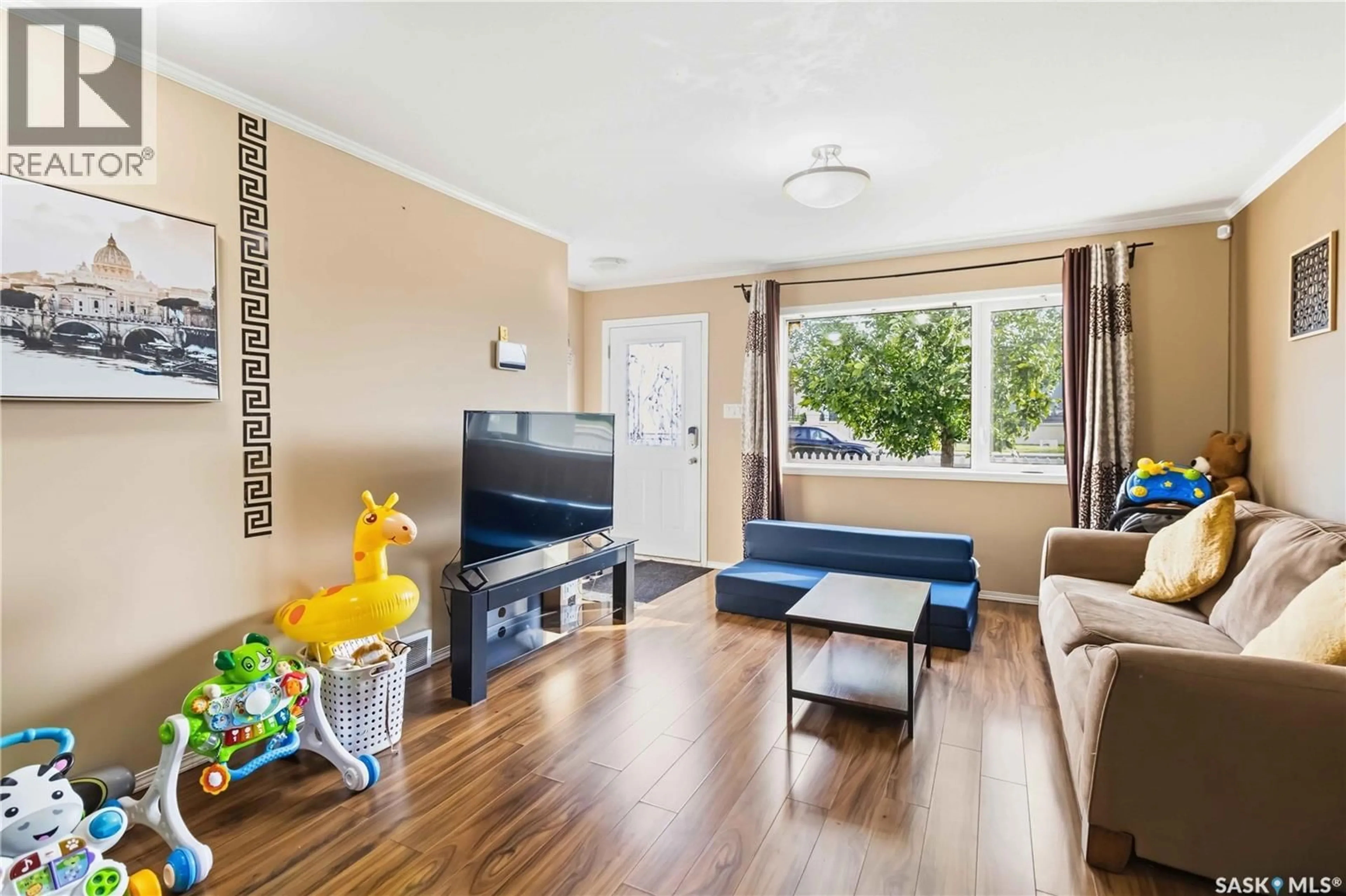 Living room with furniture, wood/laminate floor for 1303 - 115 RICHARDSON ROAD, Saskatoon Saskatchewan S7R0L1
