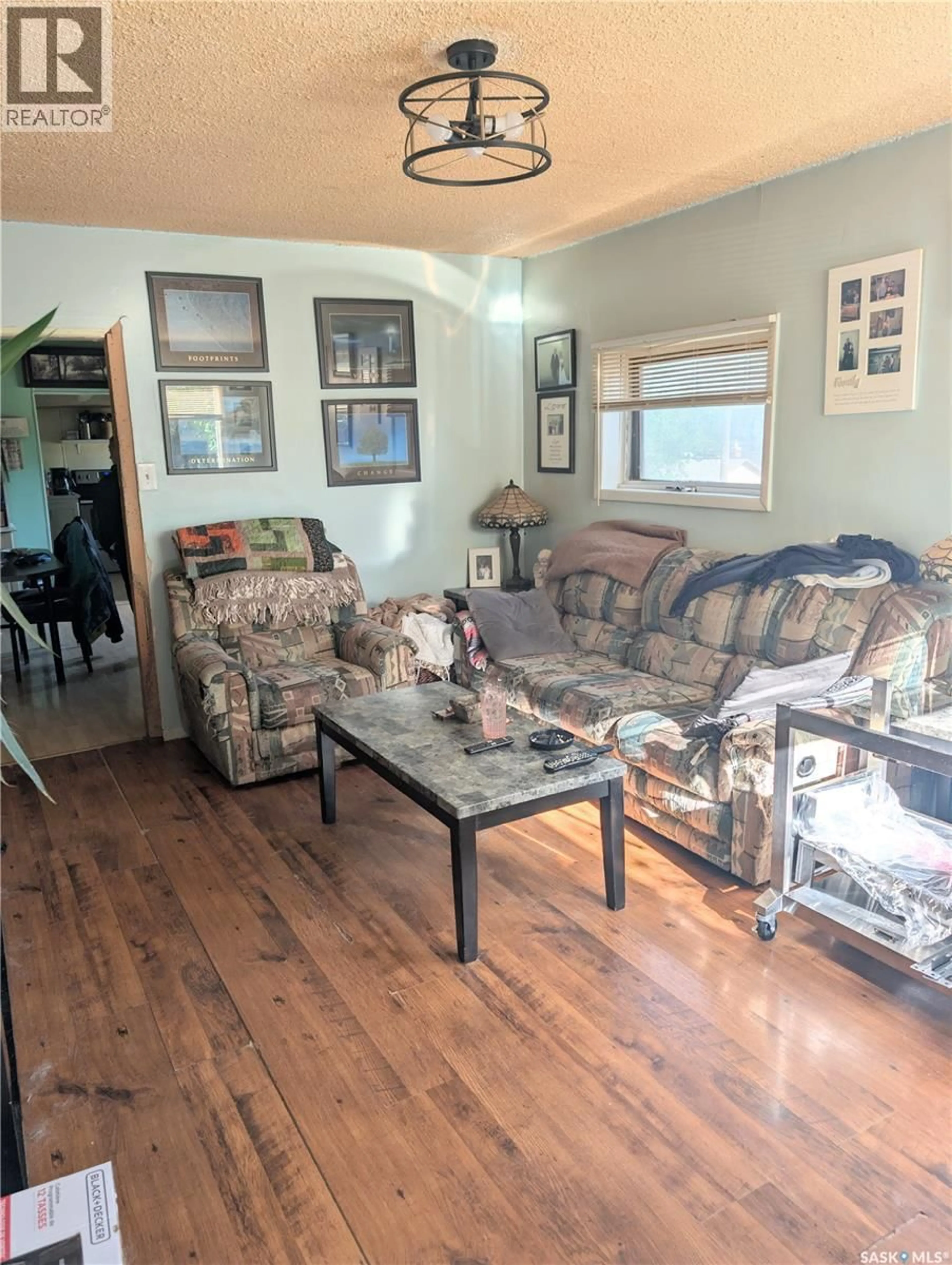 Living room with furniture, wood/laminate floor for 309 6TH AVENUE, Swift Current Saskatchewan S9H0X9