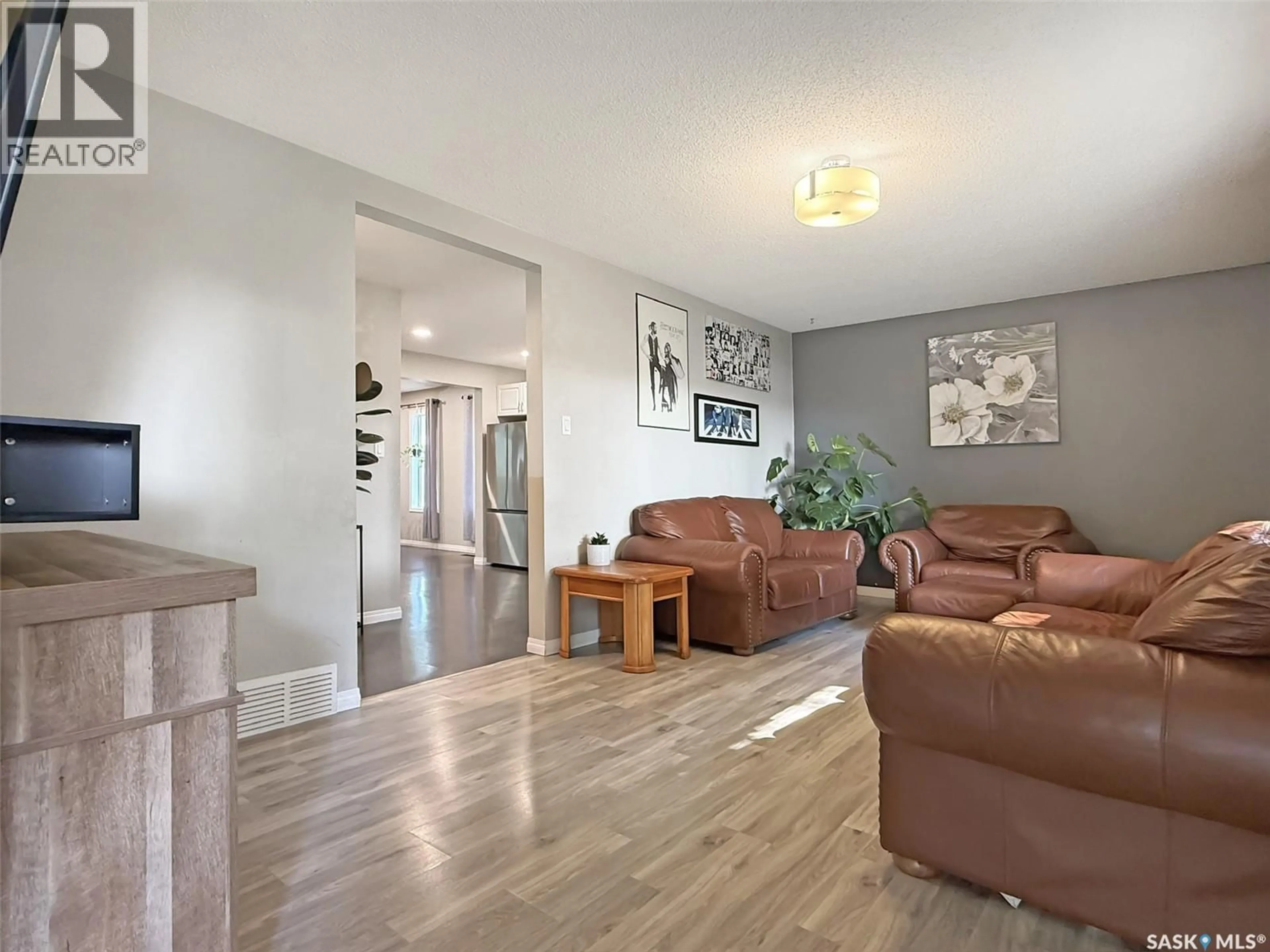 Living room with furniture, wood/laminate floor for 347 3RD AVENUE, Swift Current Saskatchewan S9H3K6