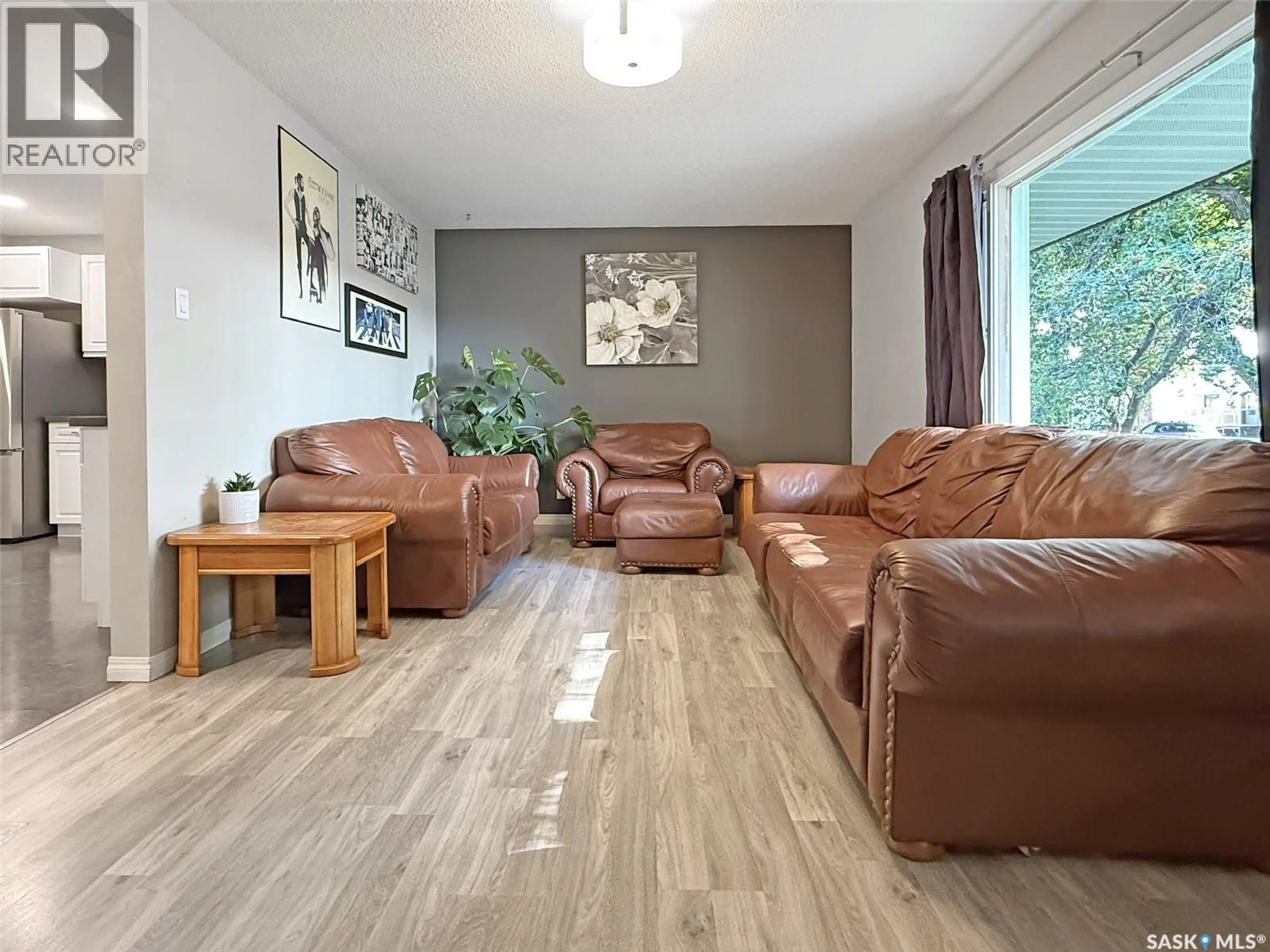 Living room with furniture, wood/laminate floor for 347 3RD AVENUE, Swift Current Saskatchewan S9H3K6