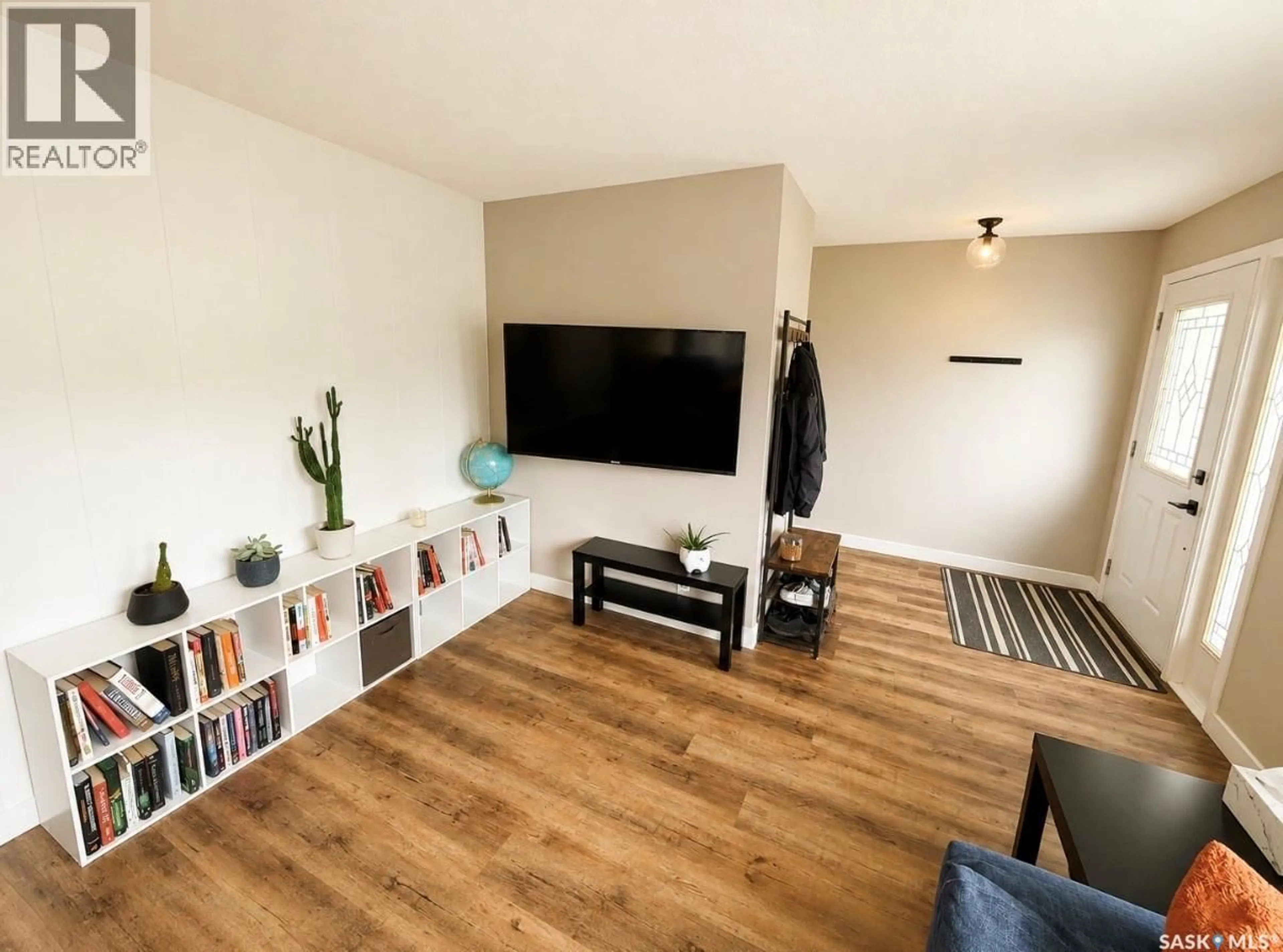 Living room with furniture, wood/laminate floor for 325 ASPEN DRIVE, Swift Current Saskatchewan S9H3Z8