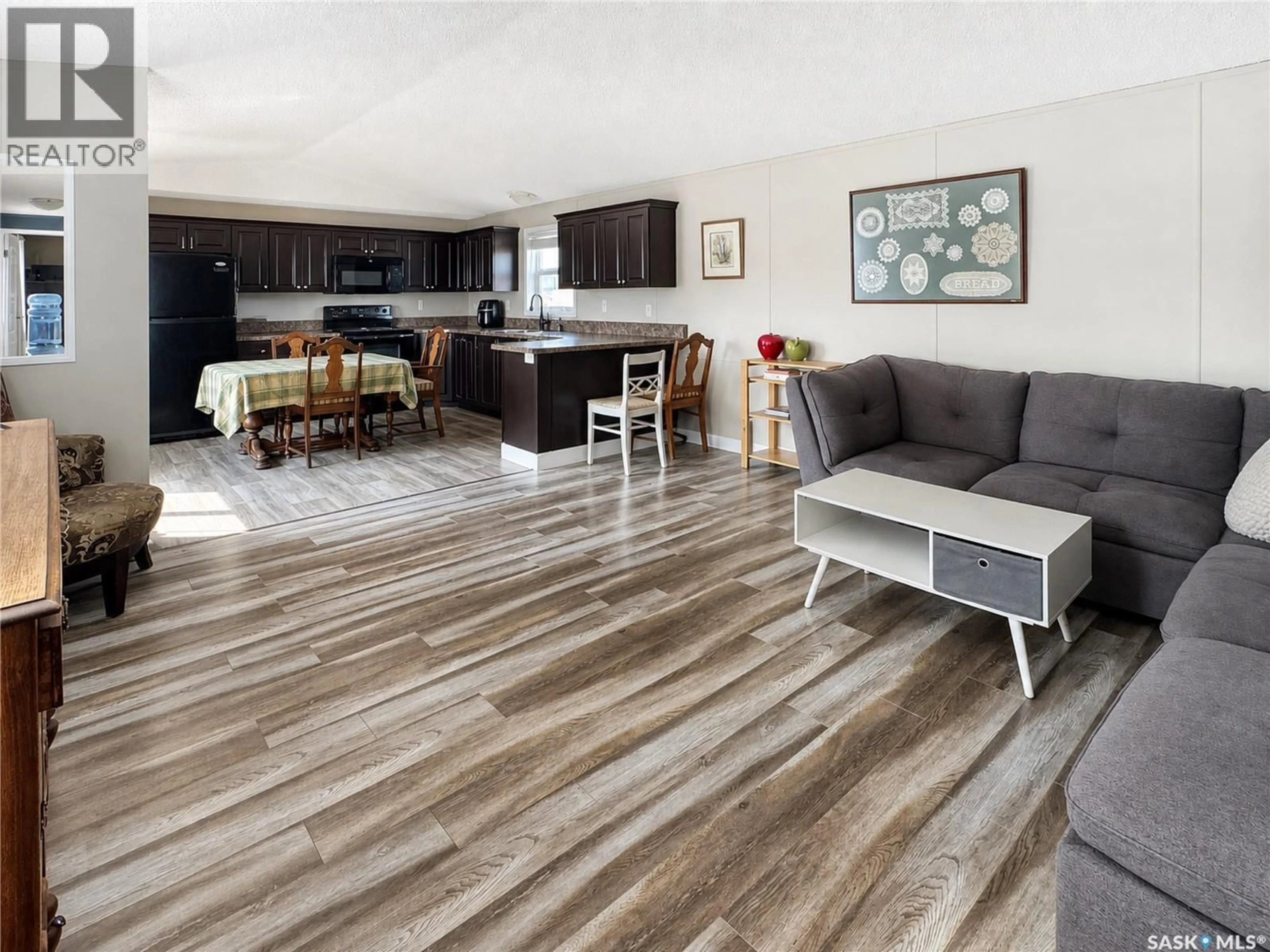 Living room with furniture, wood/laminate floor for 495 32ND STREET, Battleford Saskatchewan S0M0E0