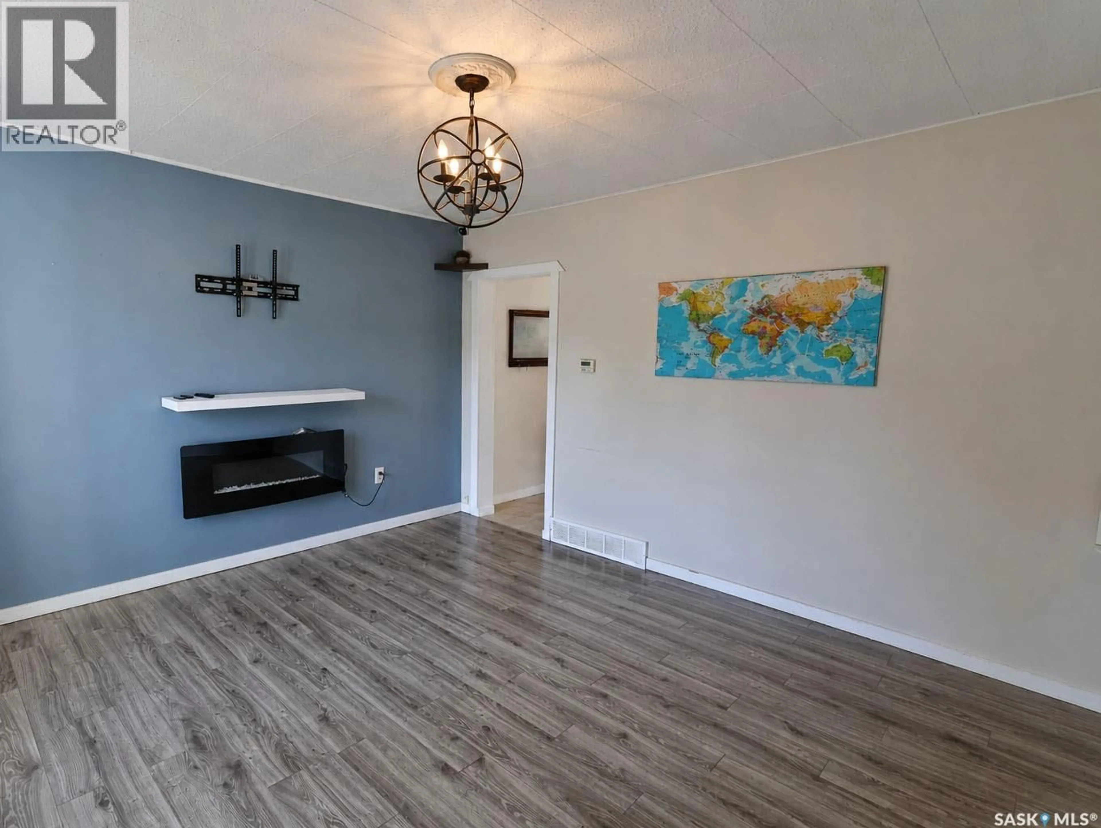 Living room with furniture, wood/laminate floor for 838 3RD STREET, Prince Albert Saskatchewan S6V0H9