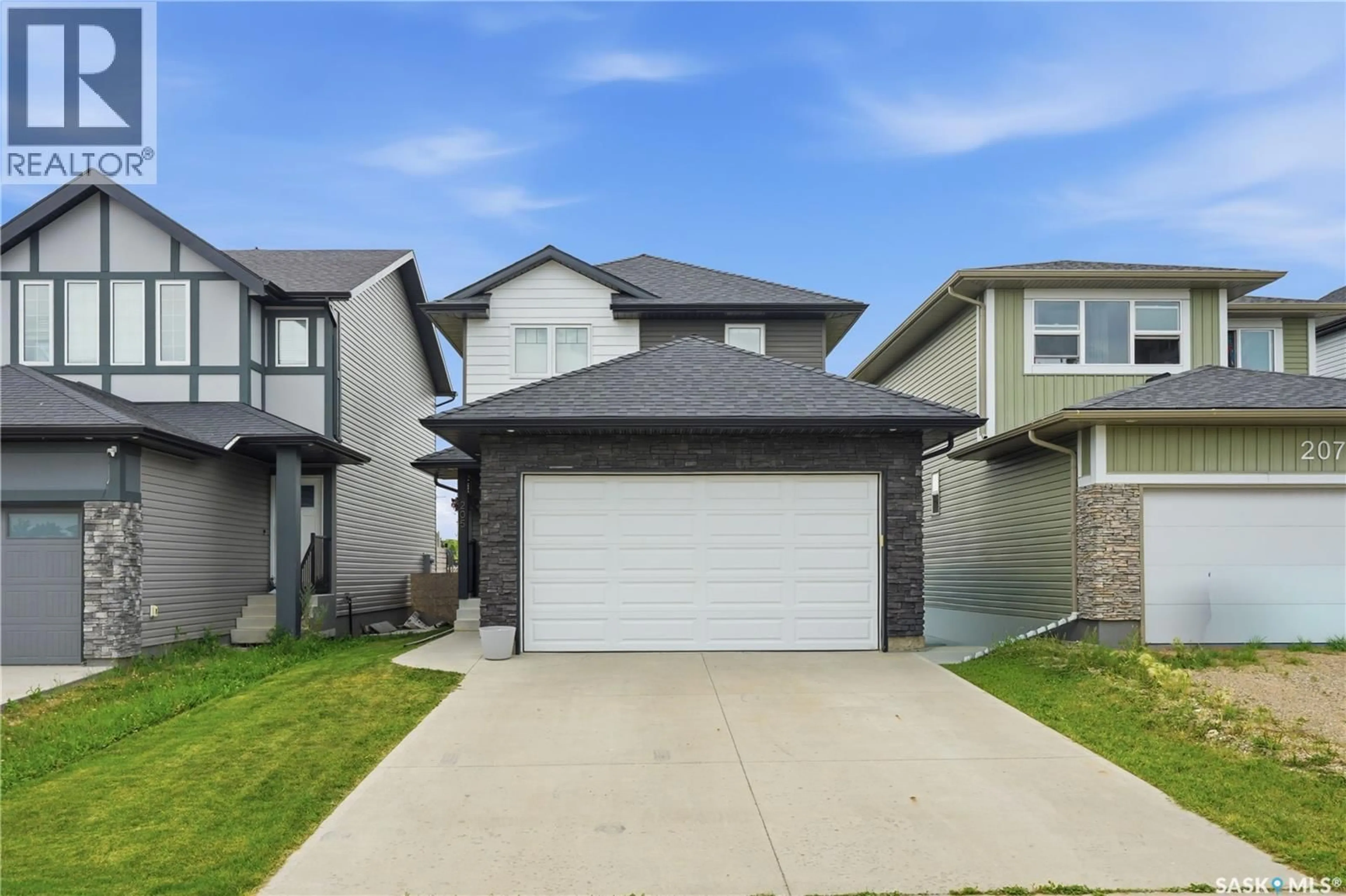 Home with vinyl exterior material, street for 205 WALL STREET, Dalmeny Saskatchewan S0K1E0