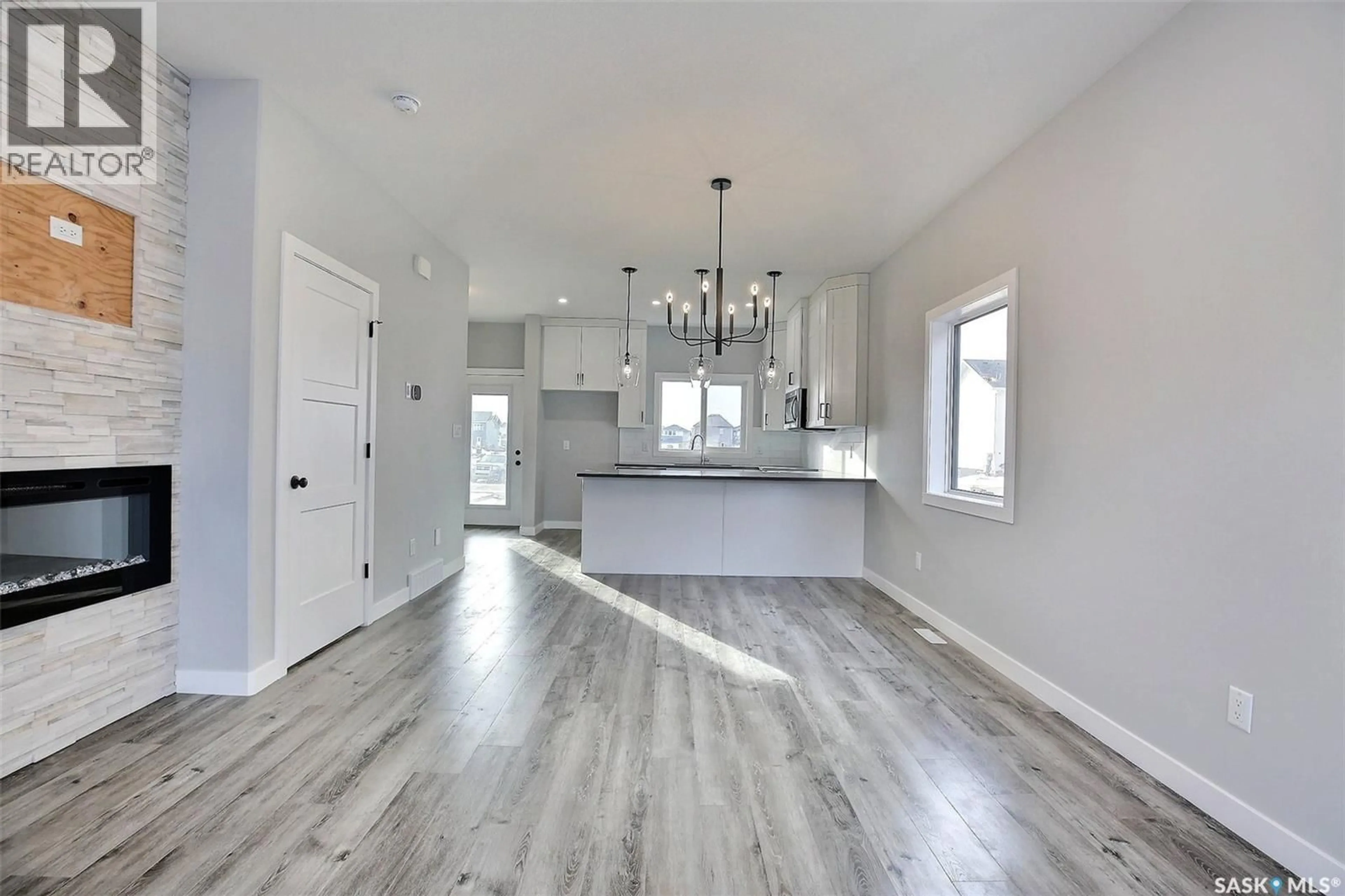 Open concept kitchen, wood/laminate floor for 2956 GREEN TURTLE ROAD, Regina Saskatchewan S4V4G4