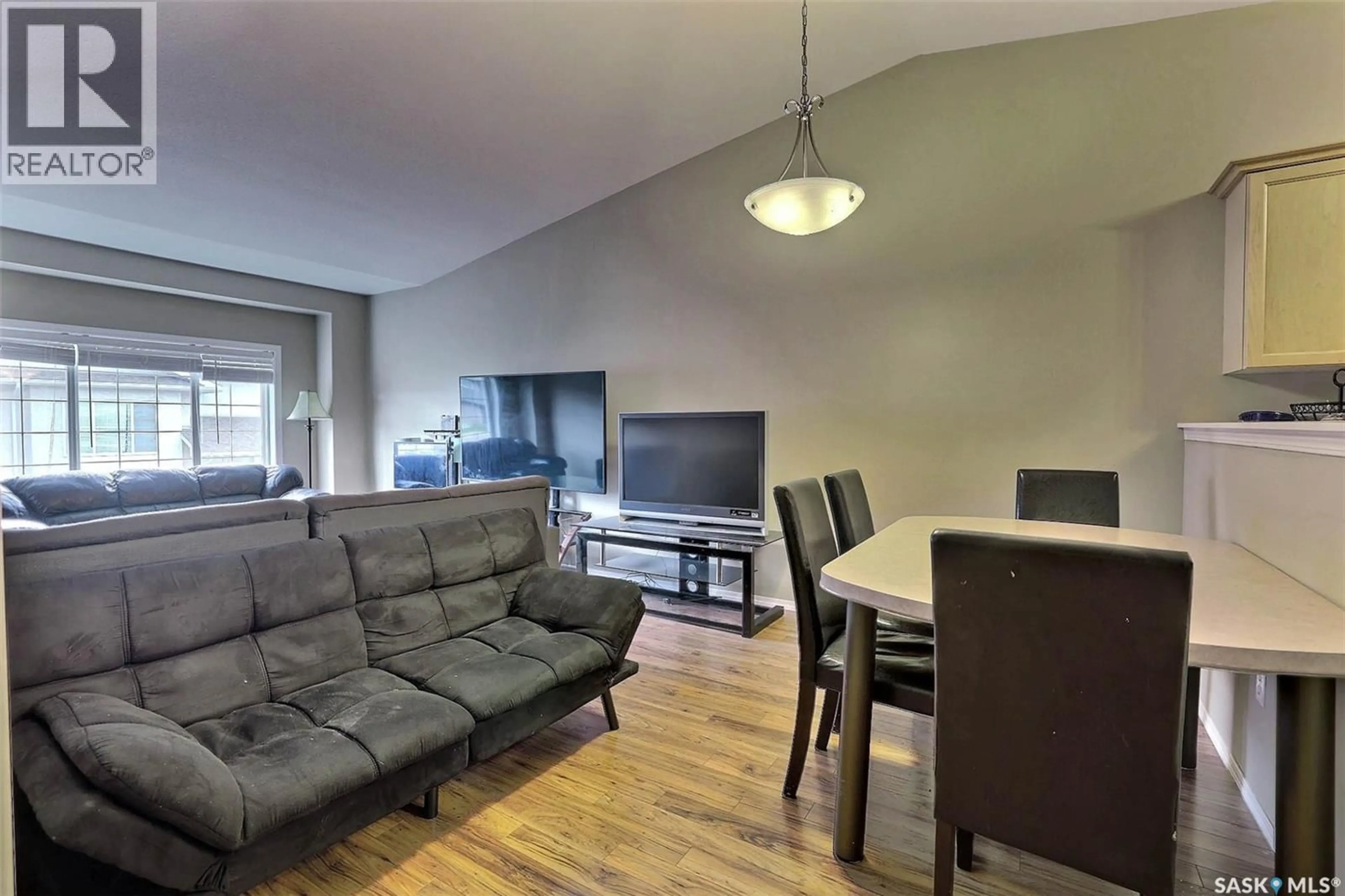 Living room with furniture, wood/laminate floor for 4425 - 53 NICURITY DRIVE, Regina Saskatchewan S4X0E6