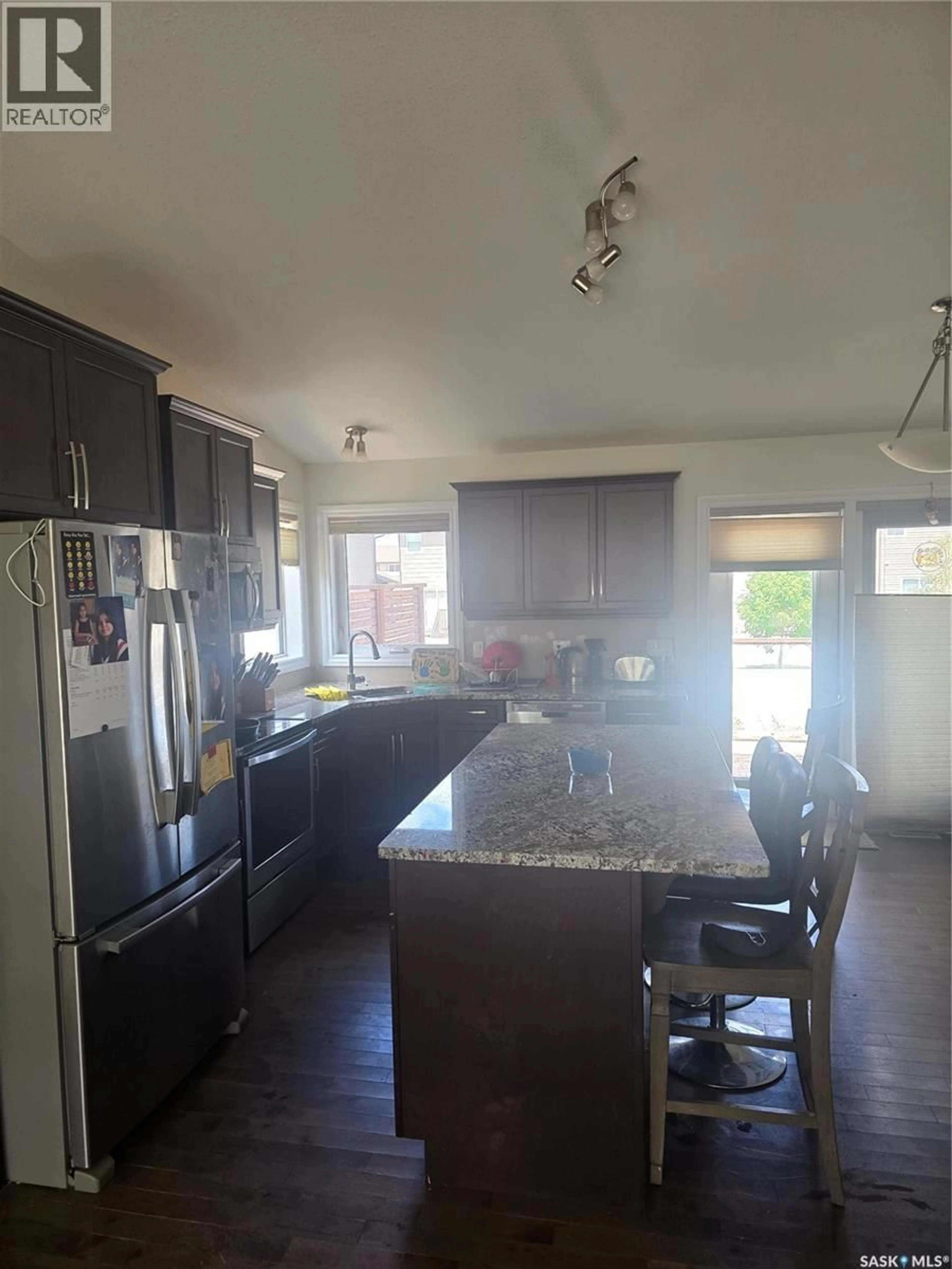 Open concept kitchen, wood/laminate floor for 444 5TH AVENUE, Pilot Butte Saskatchewan S0G3Z0