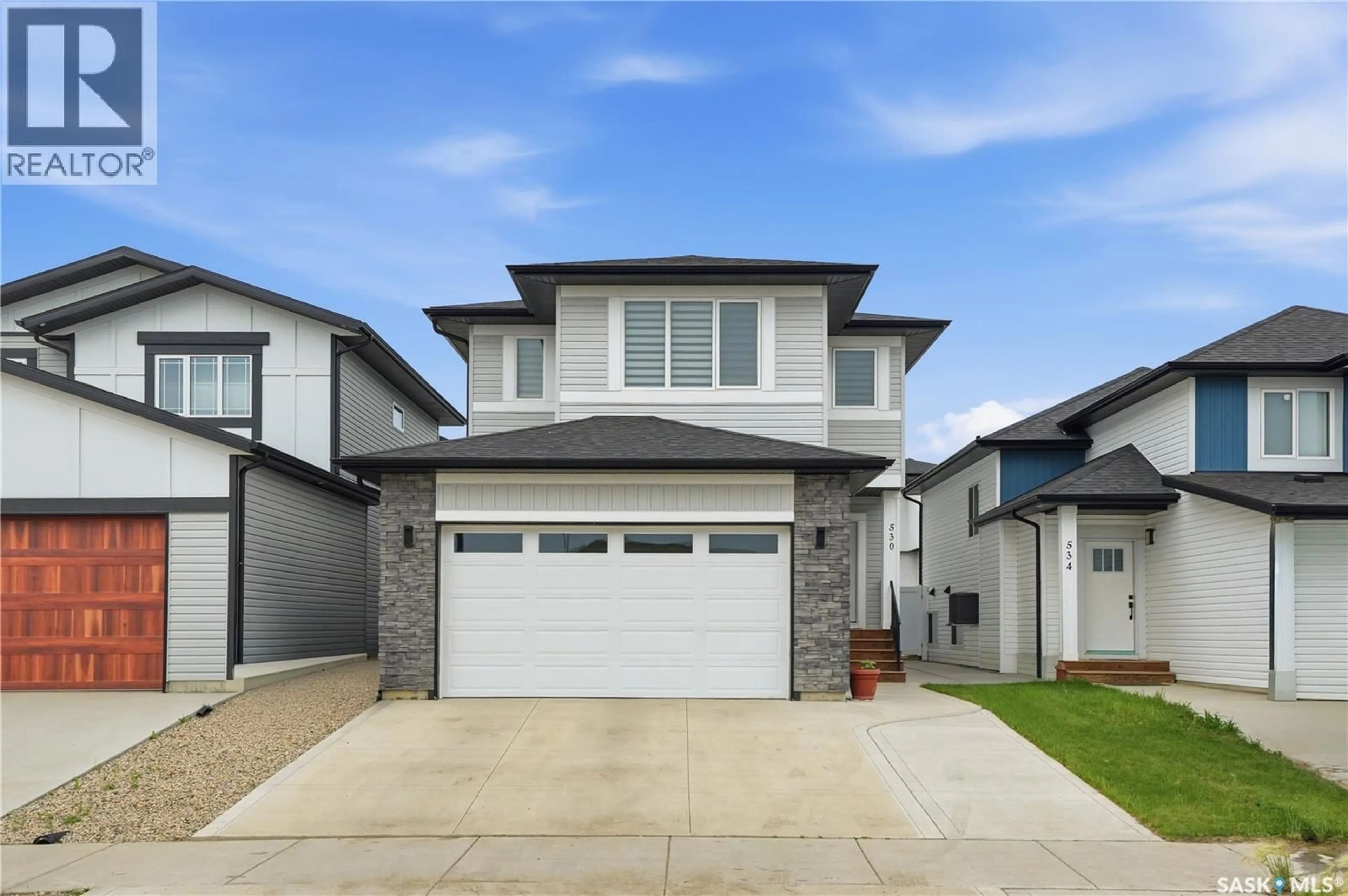 Home with vinyl exterior material, street for 530 TASKAMANWA STREET, Saskatoon Saskatchewan S7V1P8