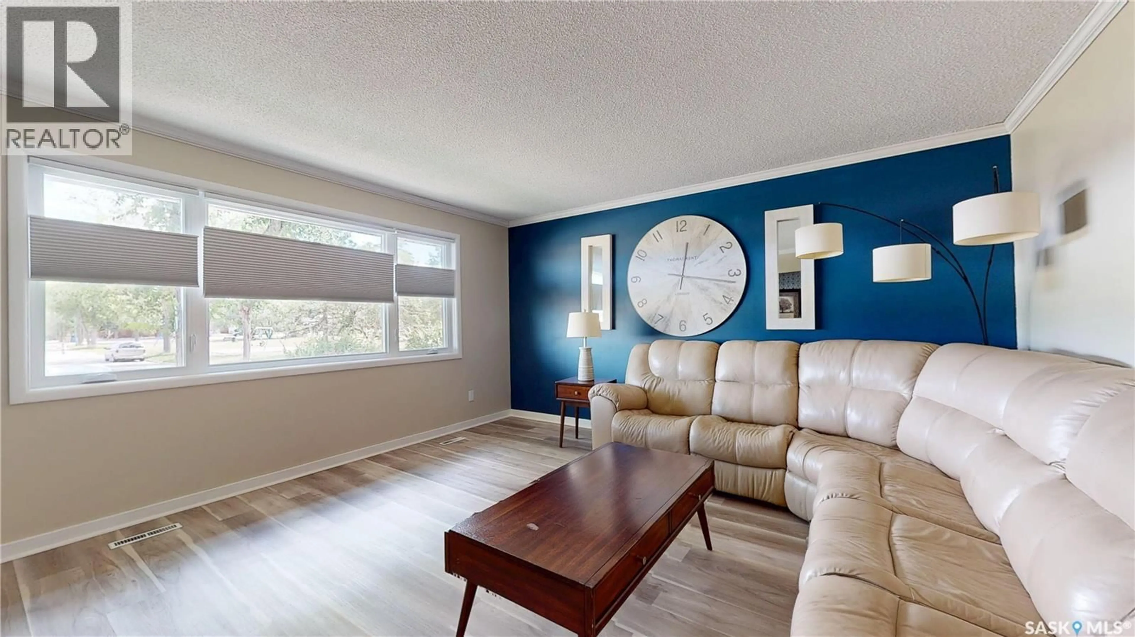 Living room with furniture, wood/laminate floor for 68 CAMERON CRESCENT, Regina Saskatchewan S4S2X2