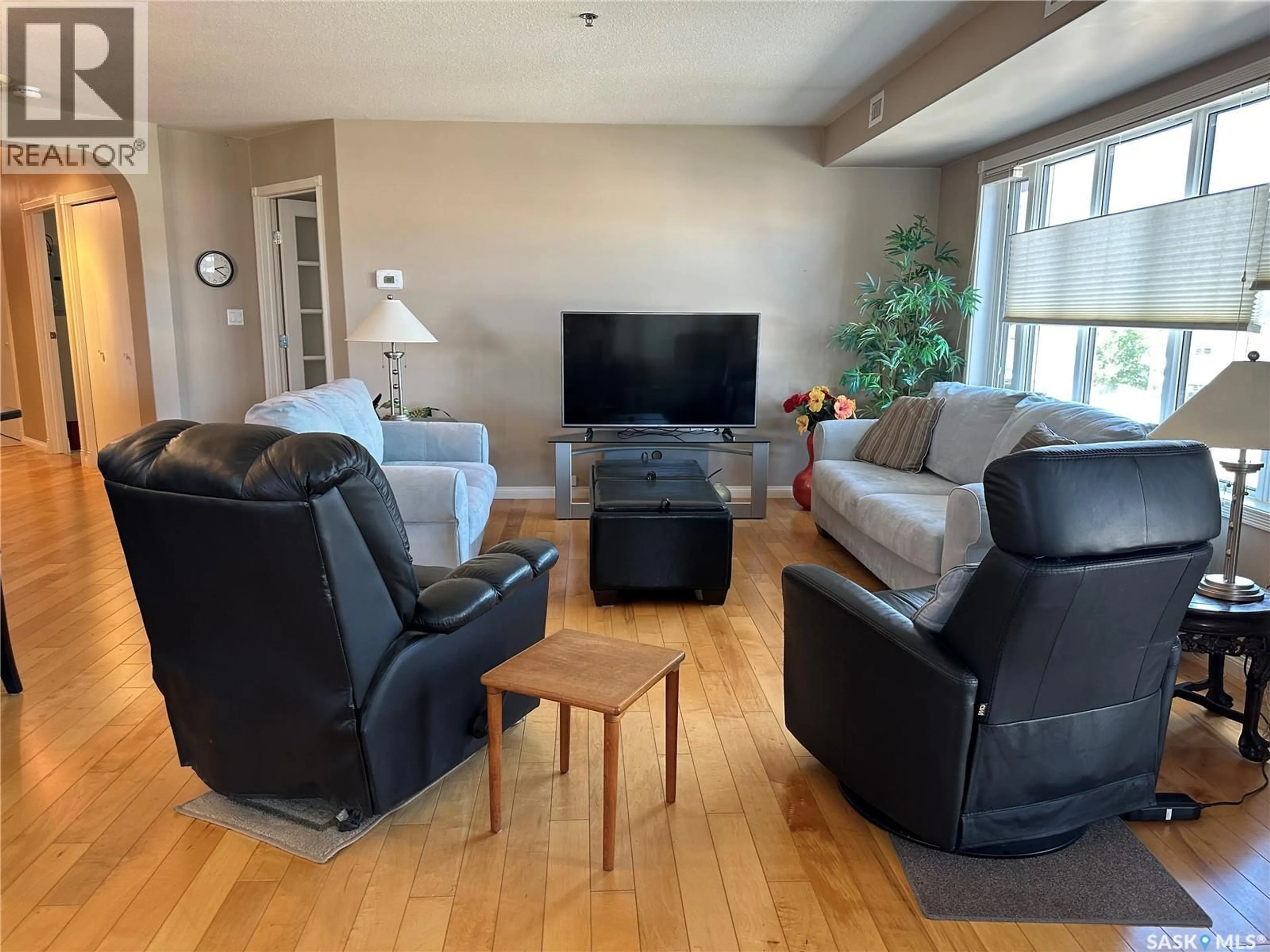 Living room with furniture, wood/laminate floor for 205 75 SOURIS AVENUE, Weyburn Saskatchewan S4H0C1