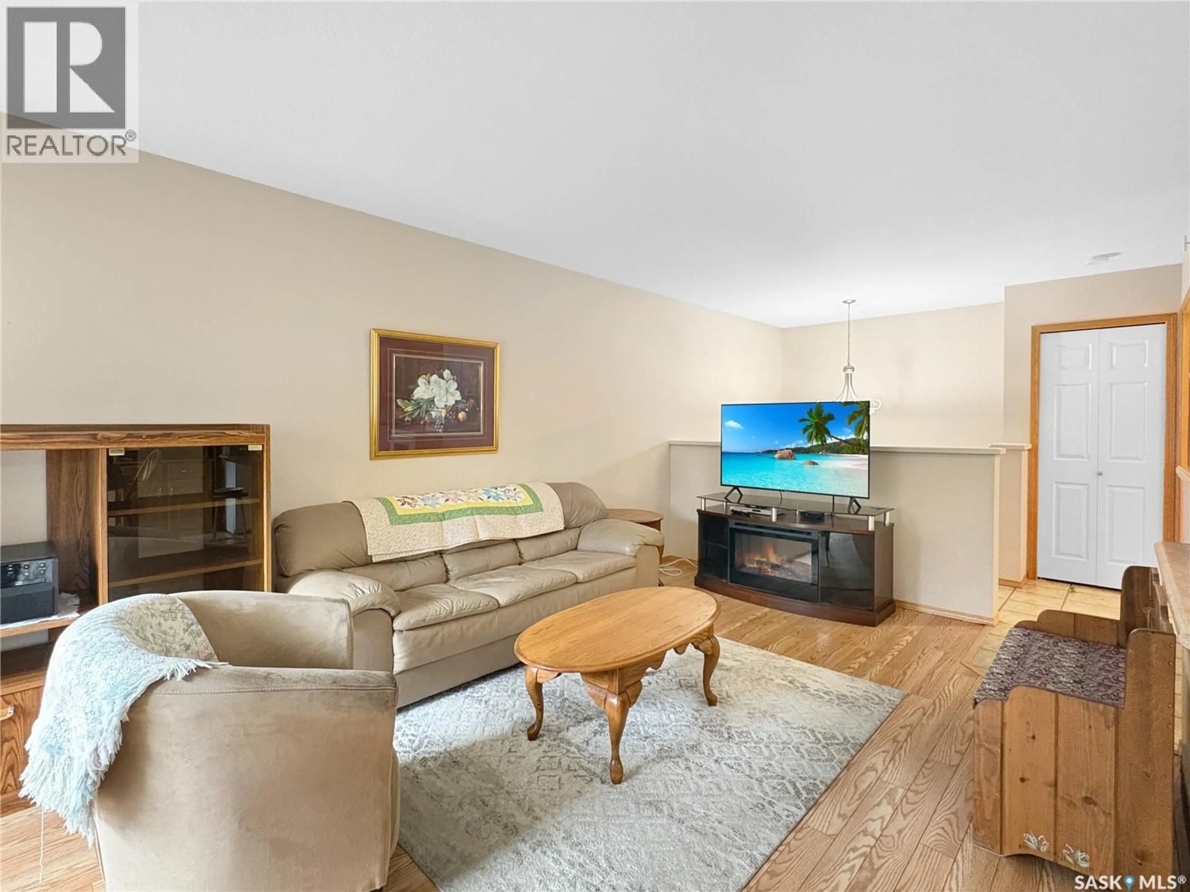 Living room with furniture, wood/laminate floor for Unit 5 - 2321 KILDEER DRIVE, North Battleford Saskatchewan S9A3T4