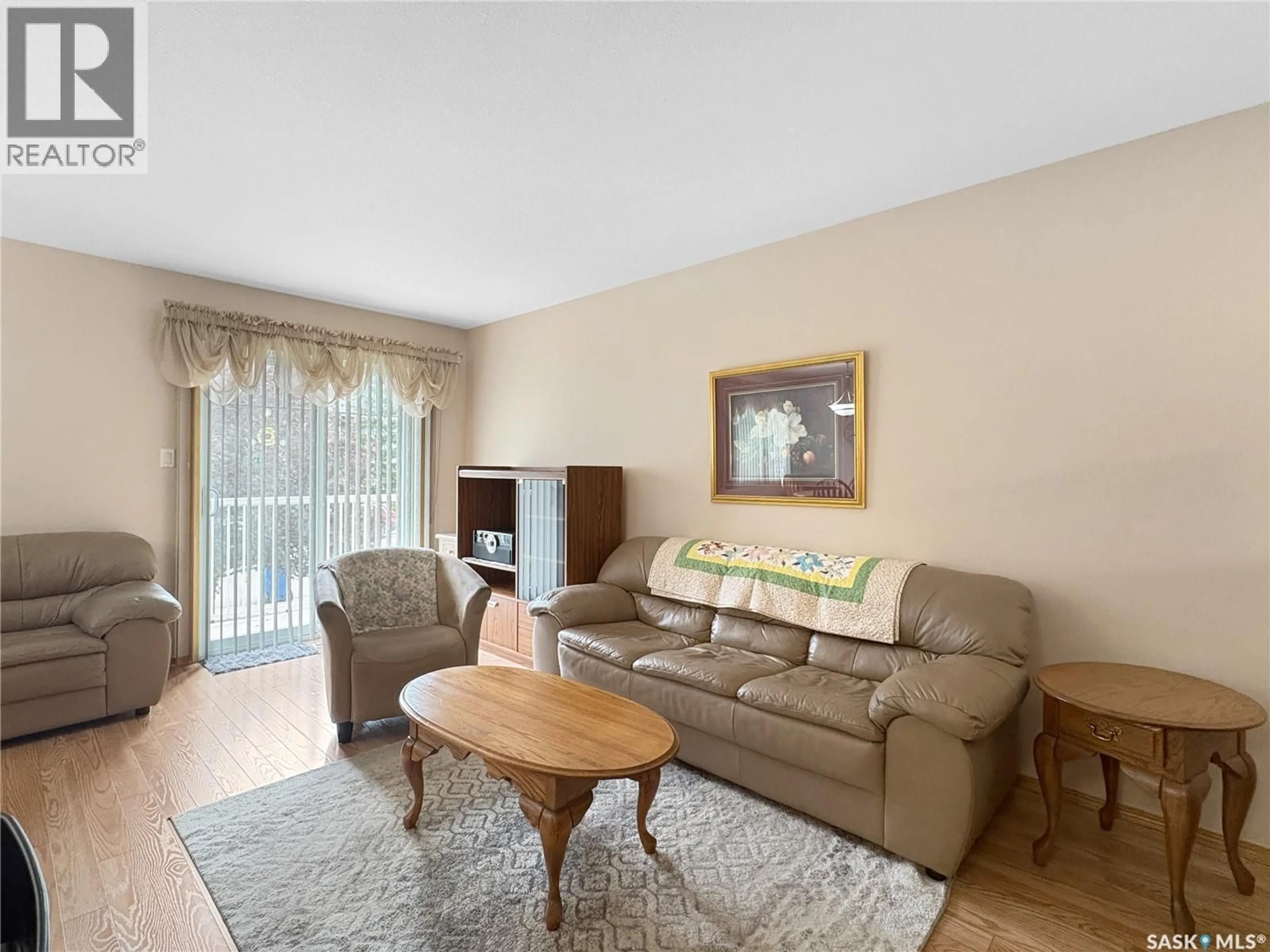 Living room with furniture, wood/laminate floor for Unit 5 - 2321 KILDEER DRIVE, North Battleford Saskatchewan S9A3T4