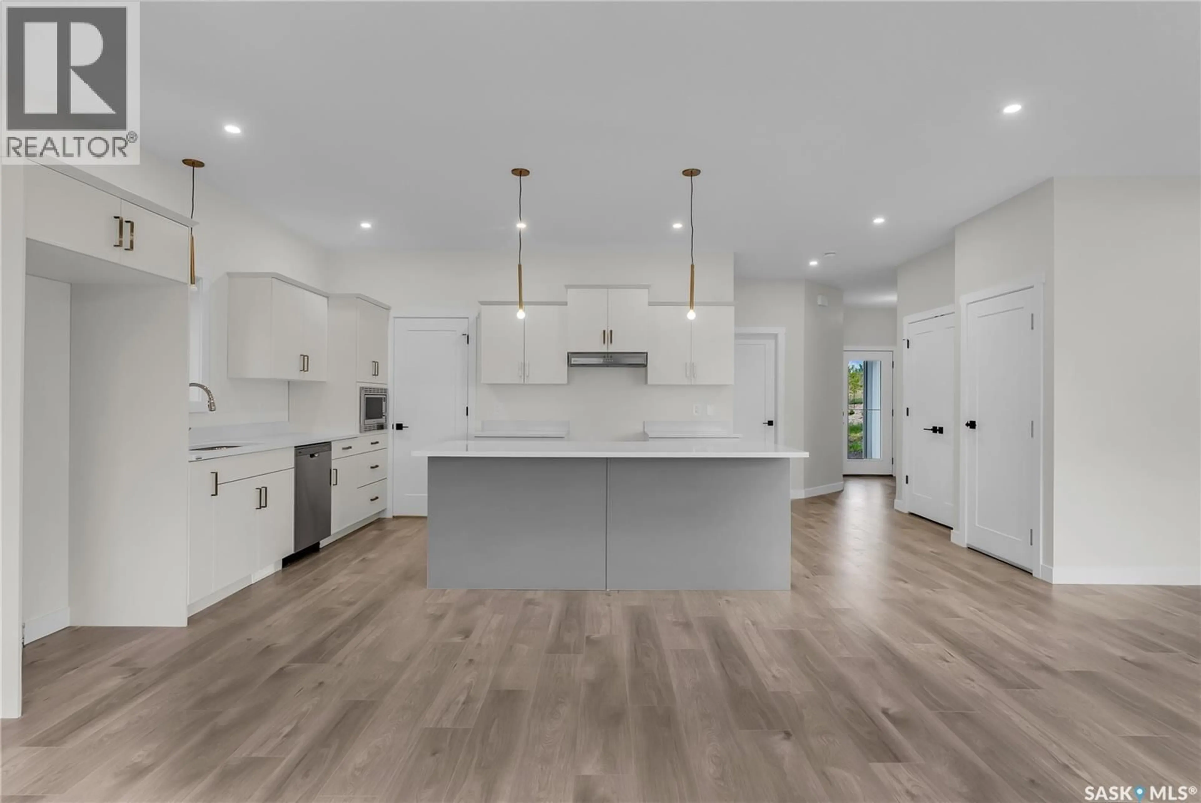 Open concept kitchen, wood/laminate floor for 207 AMISK WAY, Saskatoon Saskatchewan S7V1W5