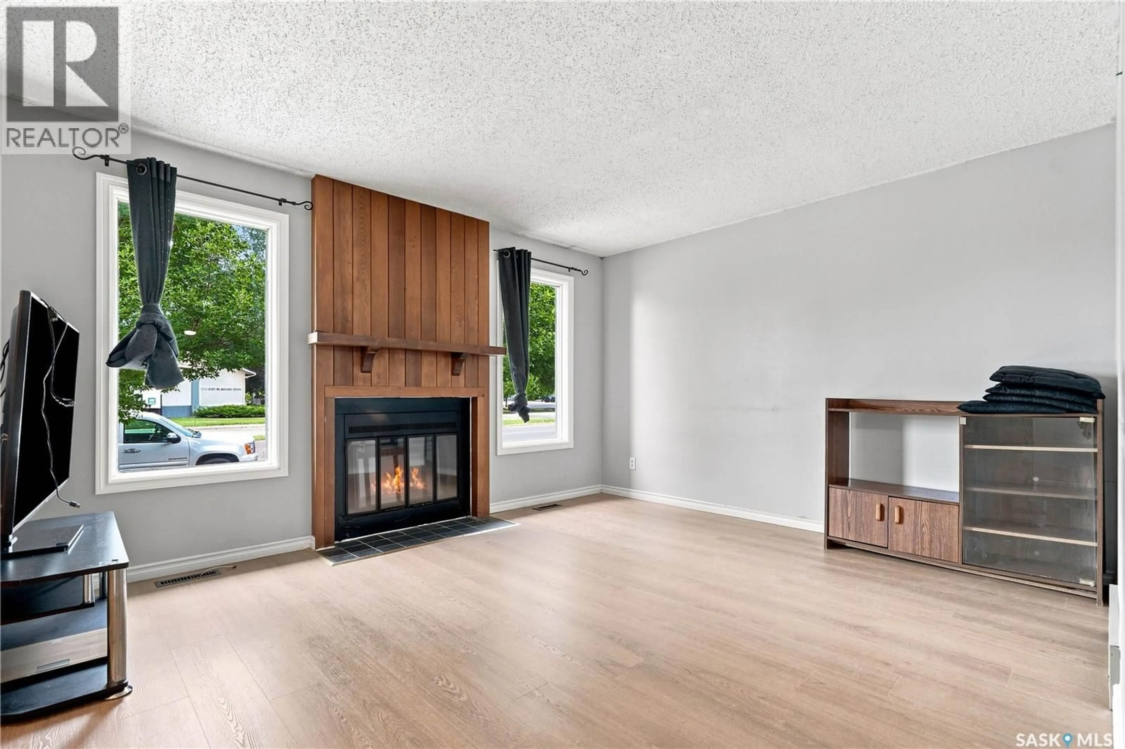 Living room with furniture, wood/laminate floor for 1718 MCKERCHER DRIVE, Saskatoon Saskatchewan S7H5E2