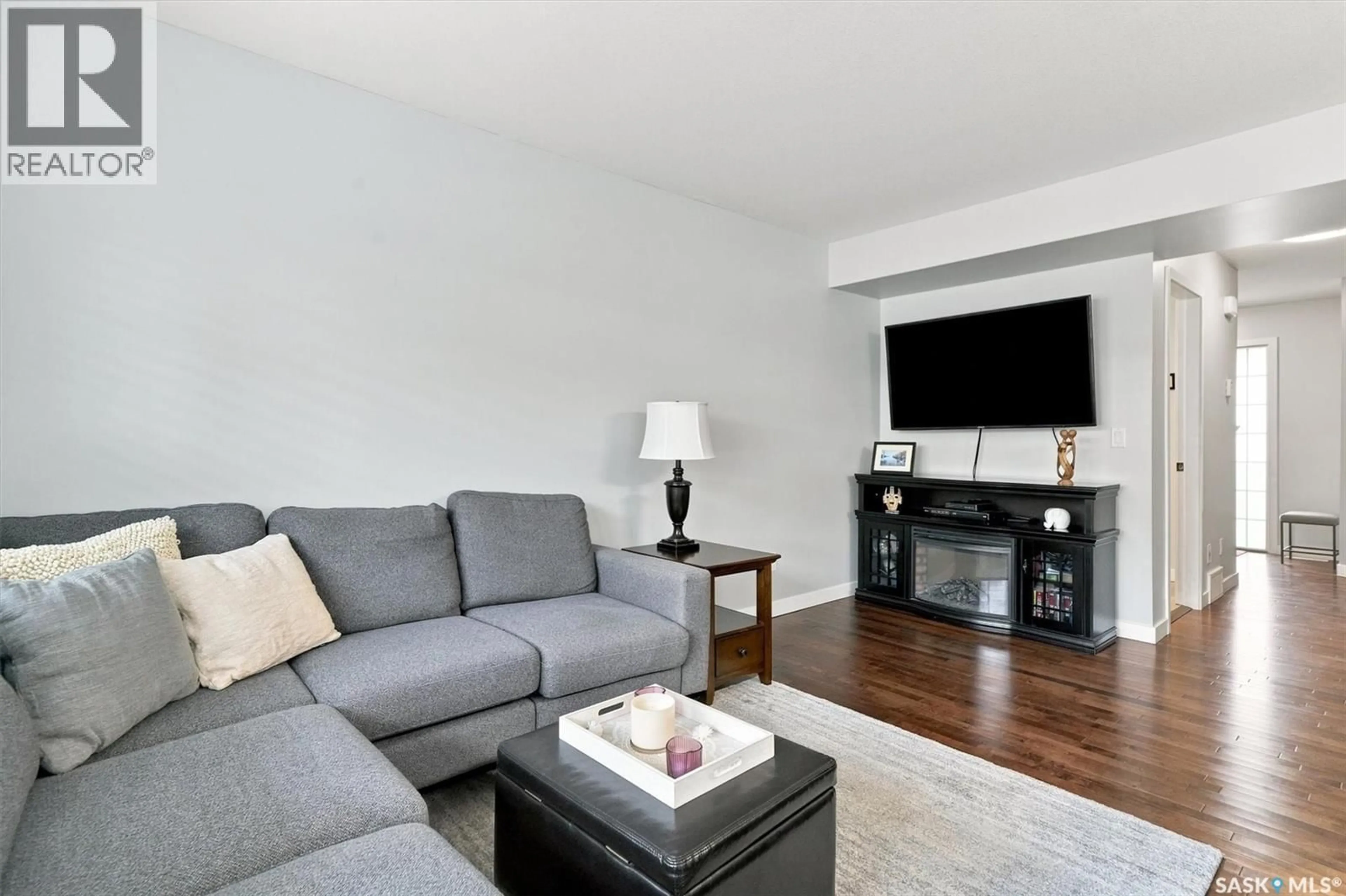 Living room with furniture, wood/laminate floor for 203 - 2007 POHORECKY CRESCENT, Saskatoon Saskatchewan S7W0V3