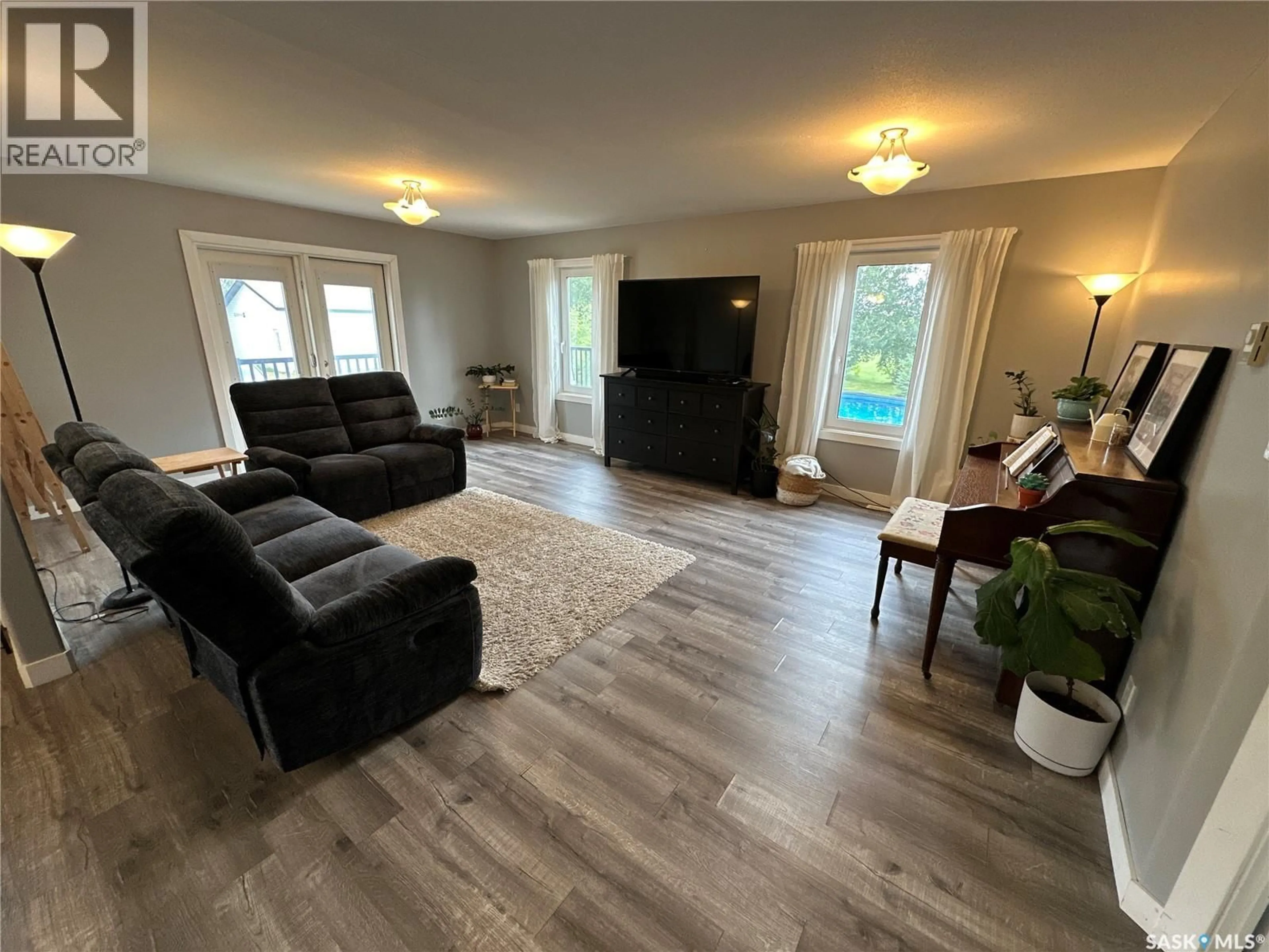 Living room with furniture, wood/laminate floor for GABRIEL BRIDGE ACREAGE, Fish Creek Rm No. 402 Saskatchewan S0K4P0