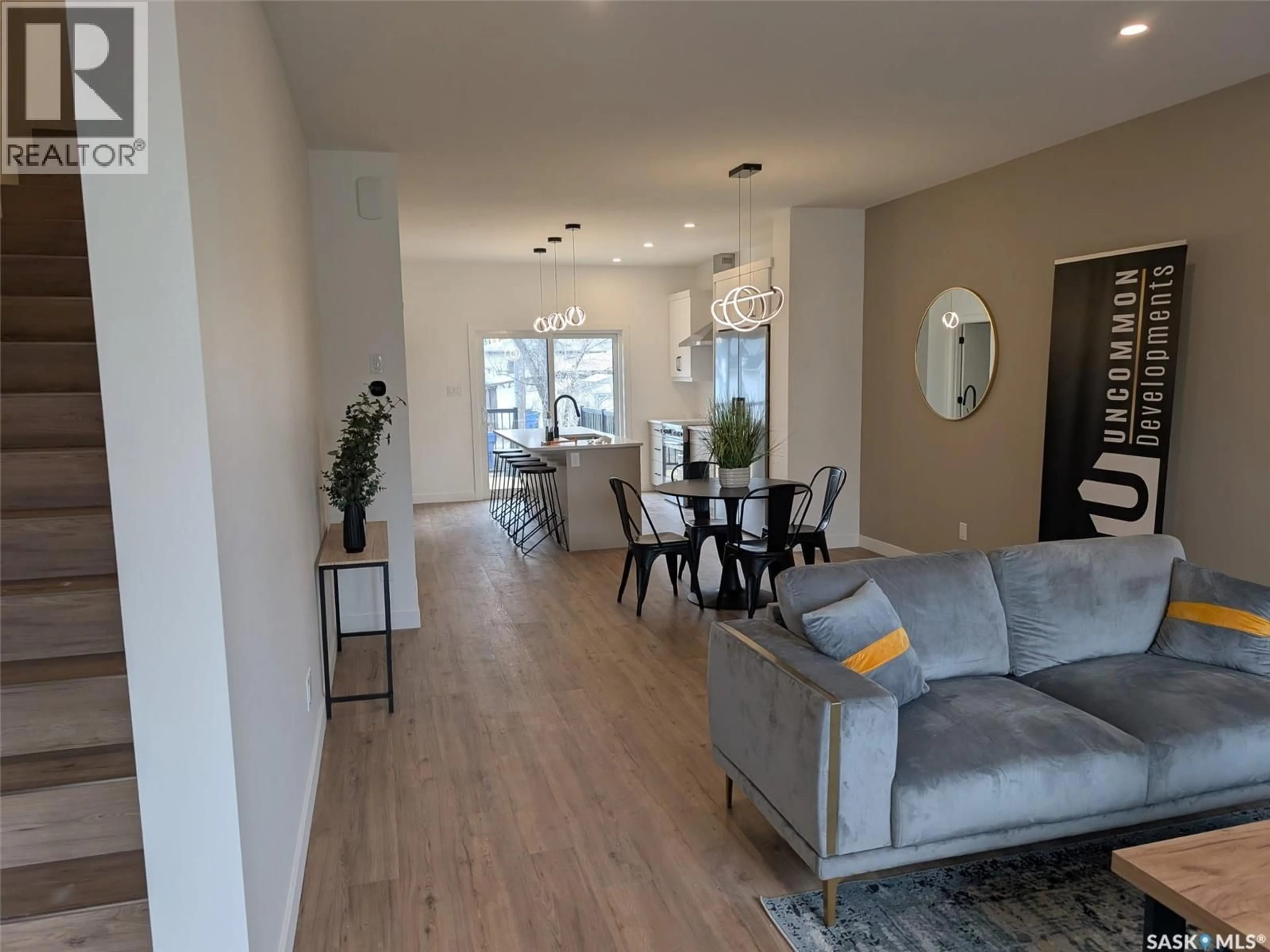 Living room with furniture, wood/laminate floor for 2460 LINDSAY STREET, Regina Saskatchewan S4N3C6