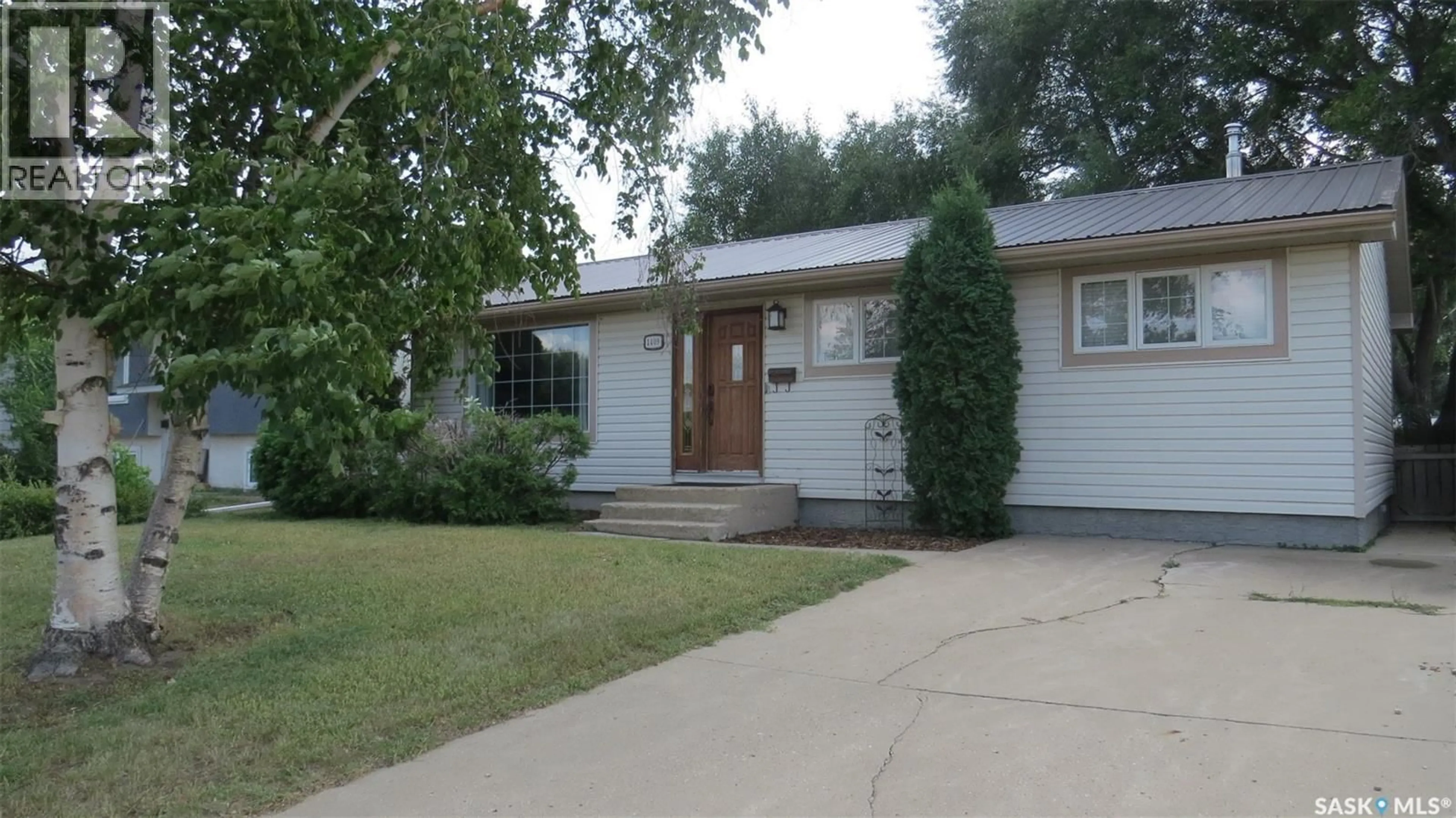 Home with vinyl exterior material, street for 1409 DUFFIELD STREET, Moose Jaw Saskatchewan S6H5K5