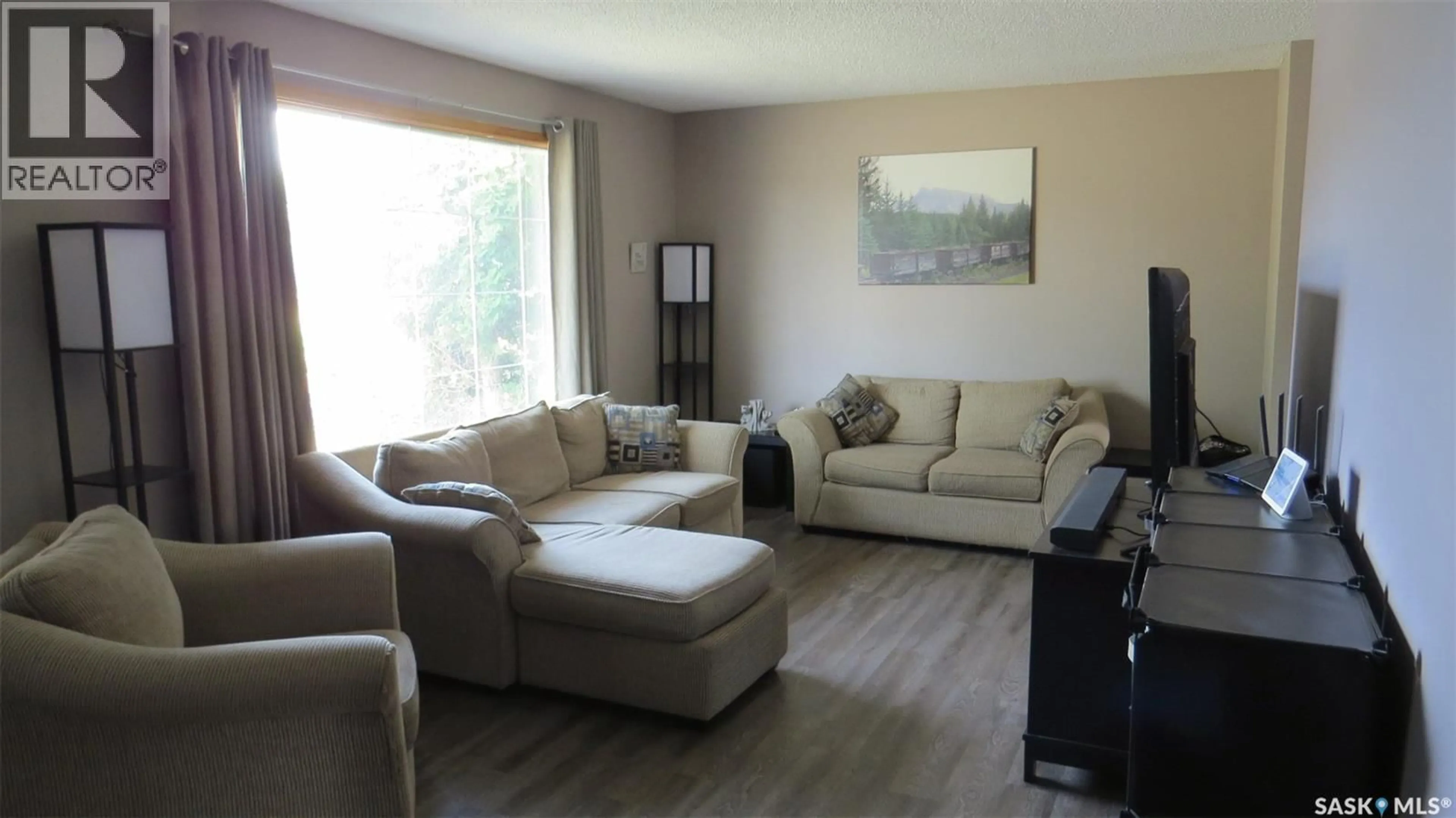 Living room with furniture, wood/laminate floor for 1409 DUFFIELD STREET, Moose Jaw Saskatchewan S6H5K5