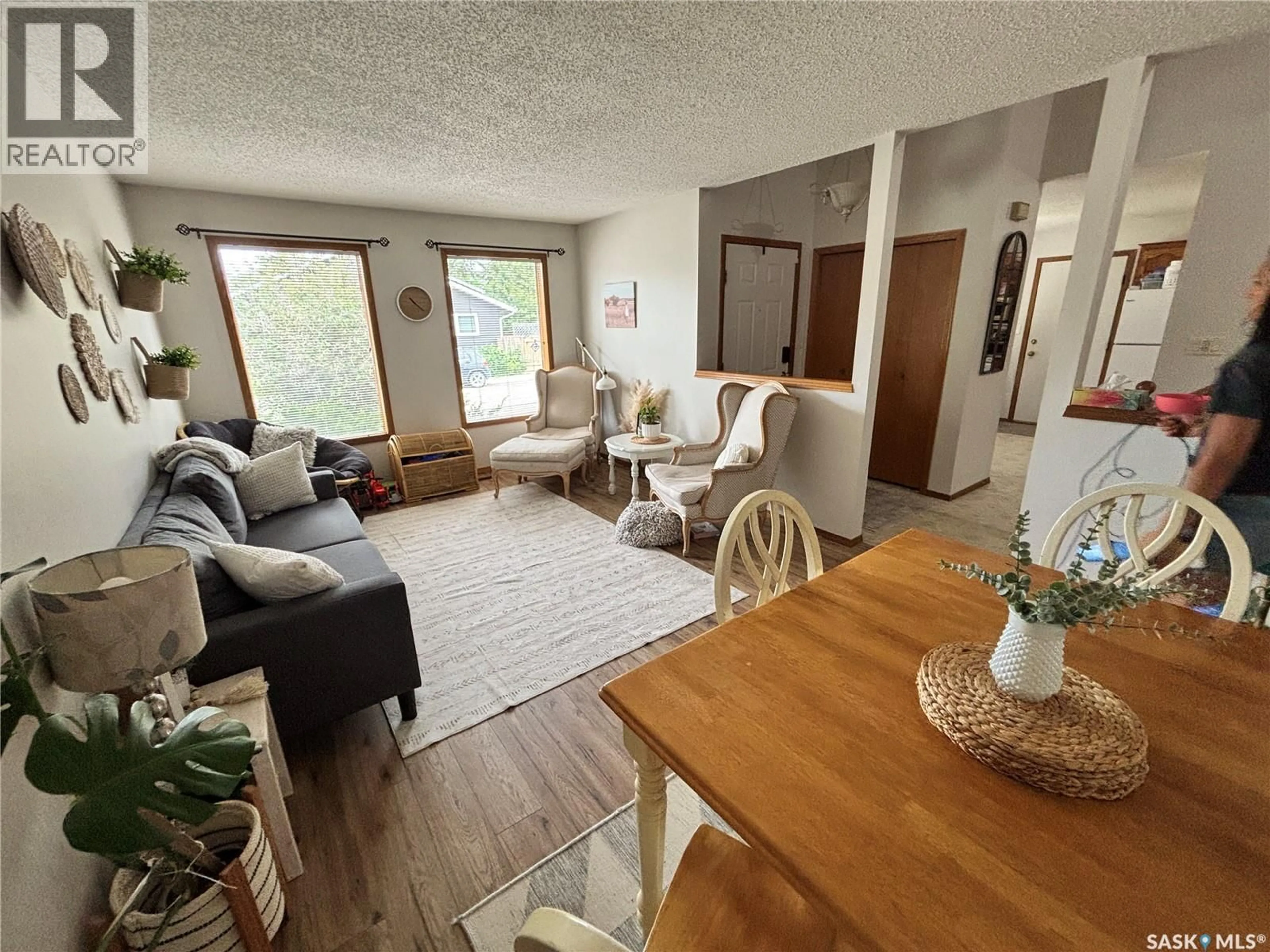 Living room with furniture, wood/laminate floor for 207 NEMEIBEN ROAD, Saskatoon Saskatchewan S7J4S8
