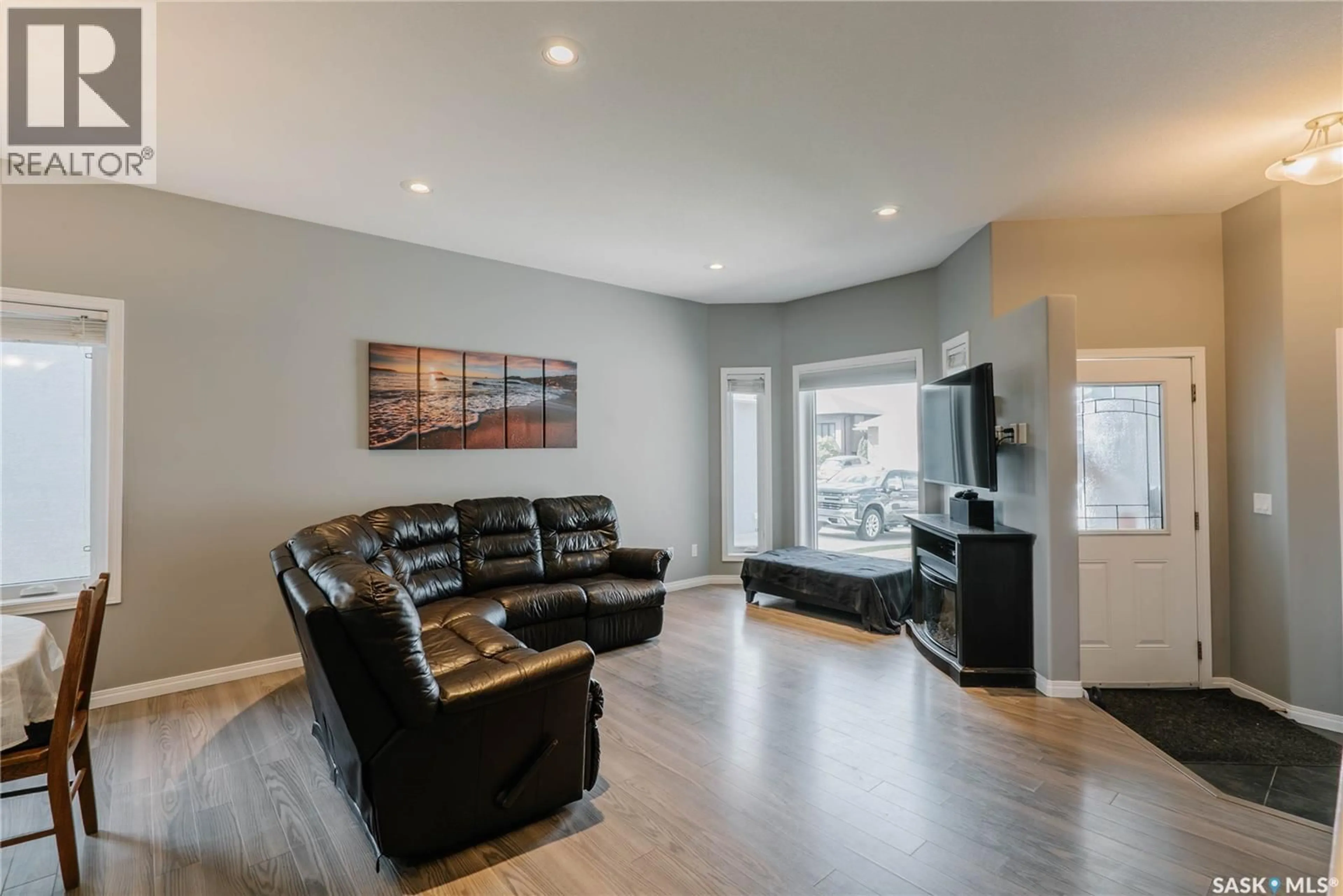 Living room with furniture, wood/laminate floor for 714 SUTTER CRESCENT, Saskatoon Saskatchewan S7T0R4