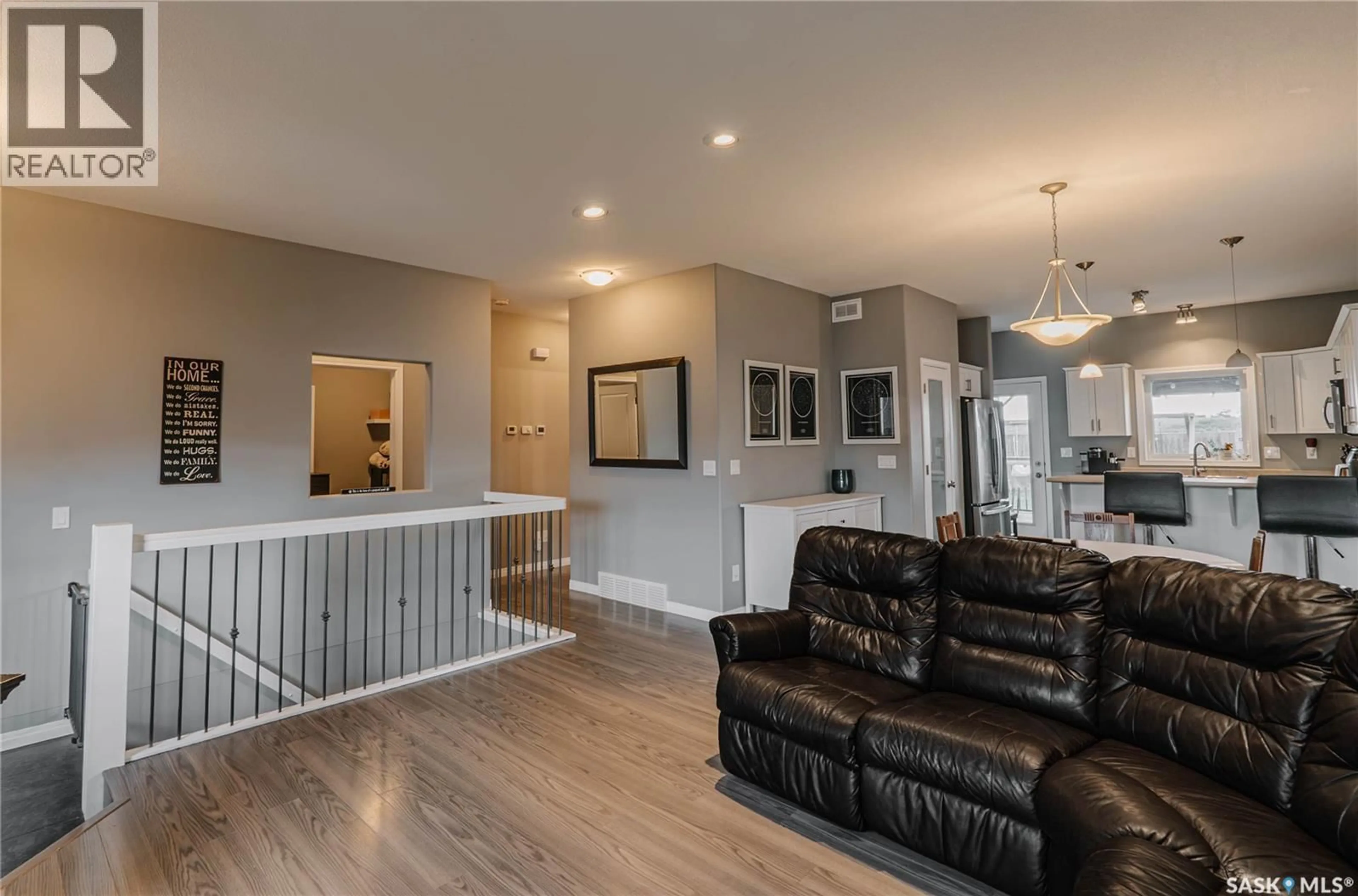 Living room with furniture, wood/laminate floor for 714 SUTTER CRESCENT, Saskatoon Saskatchewan S7T0R4