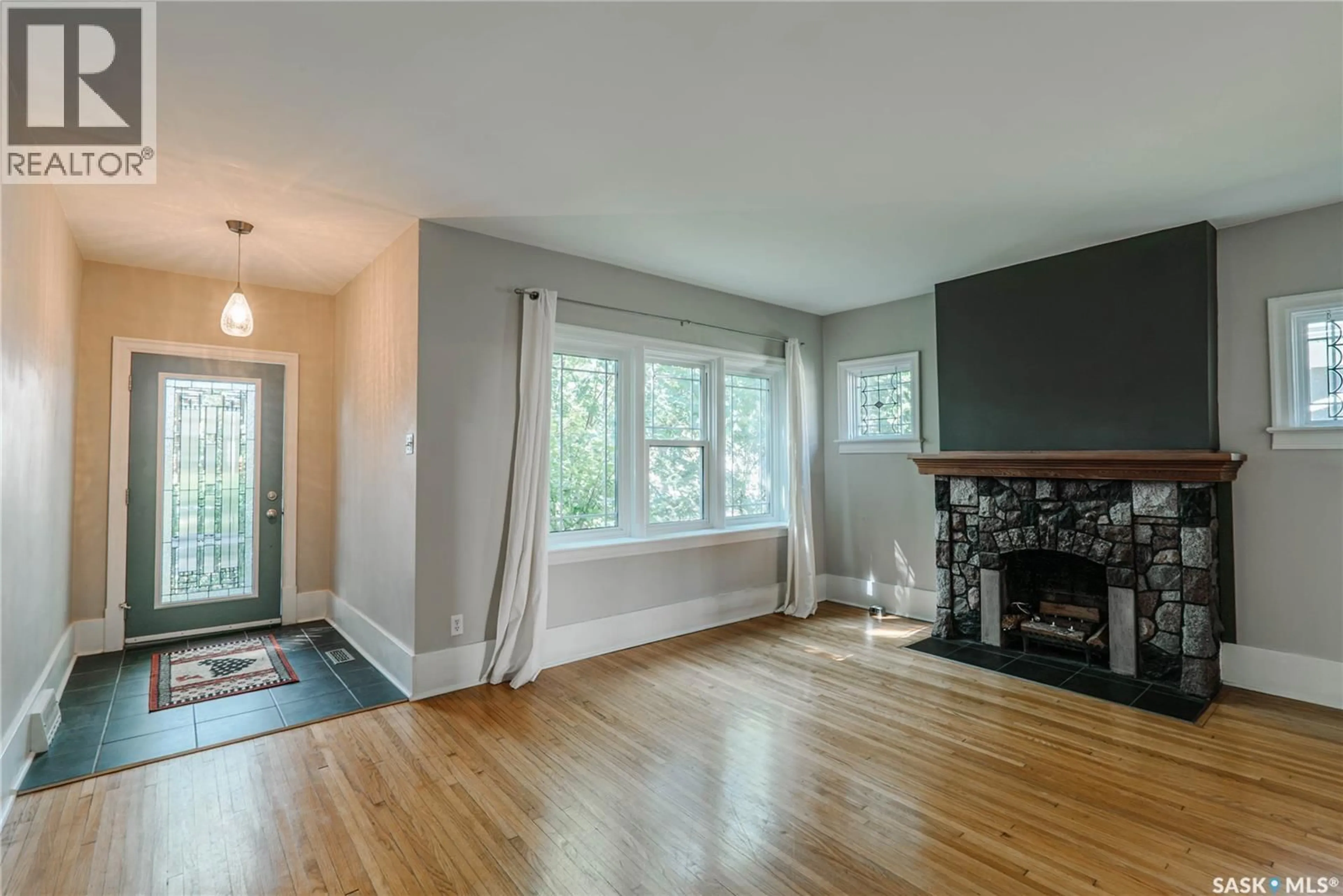 Living room with furniture, wood/laminate floor for 903 10TH STREET, Saskatoon Saskatchewan S7H0H6