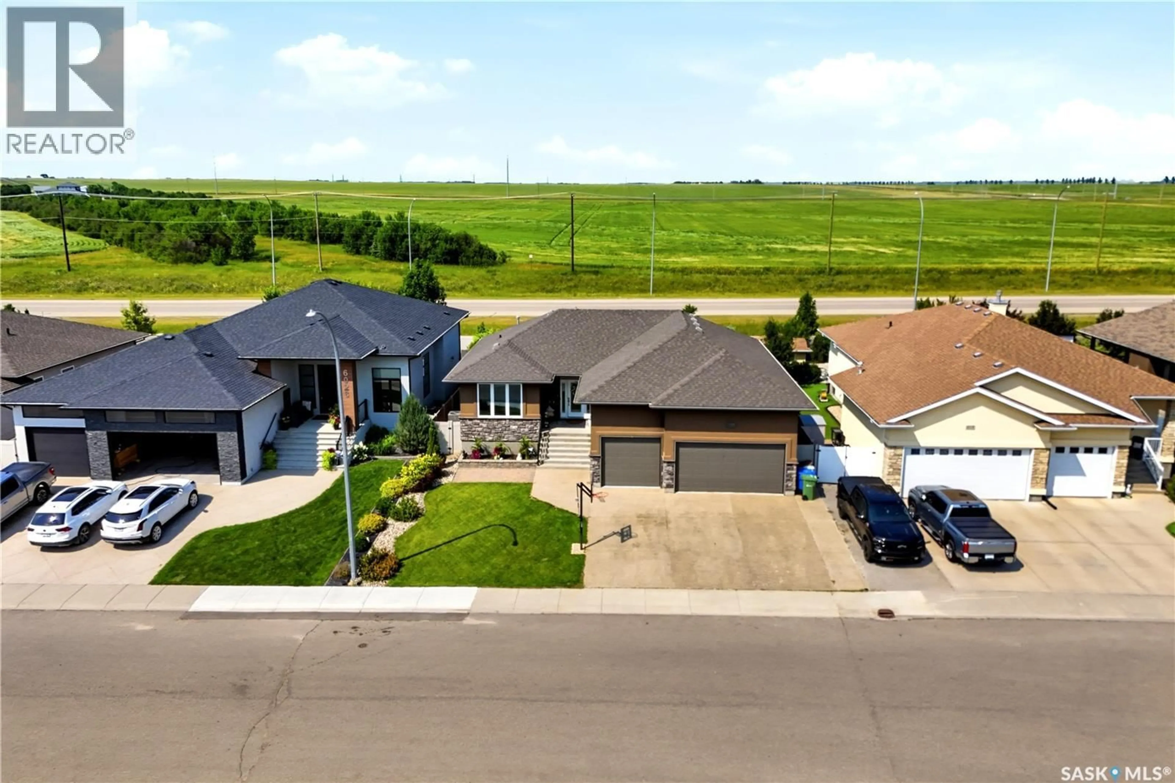A pic from outside/outdoor area/front of a property/back of a property/a pic from drone, street for 6024 LITTLE PINE LOOP, Regina Saskatchewan S4X0H5