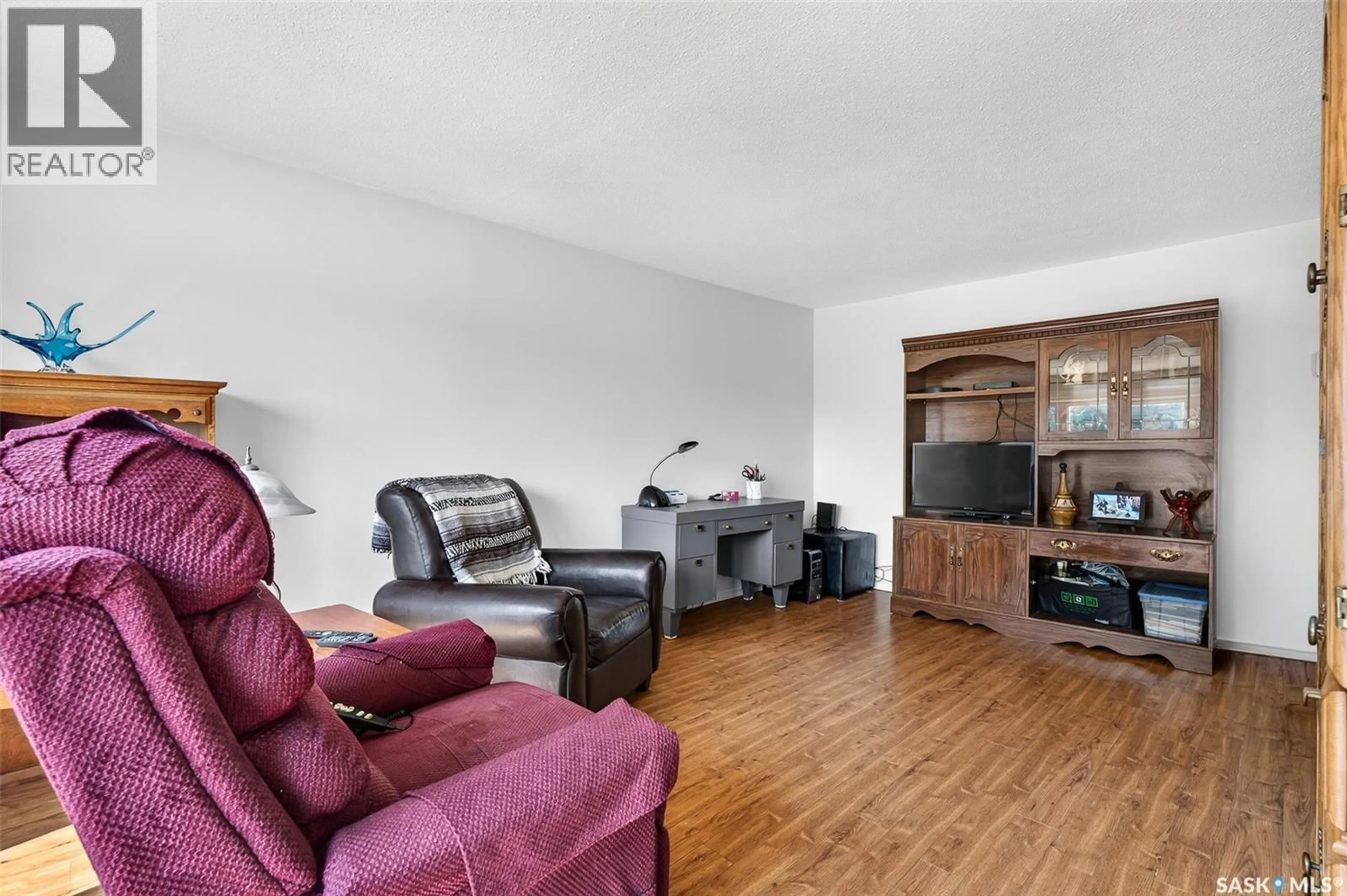 Living room with furniture, wood/laminate floor for 1006 WARNER STREET, Moose Jaw Saskatchewan S6H5S5