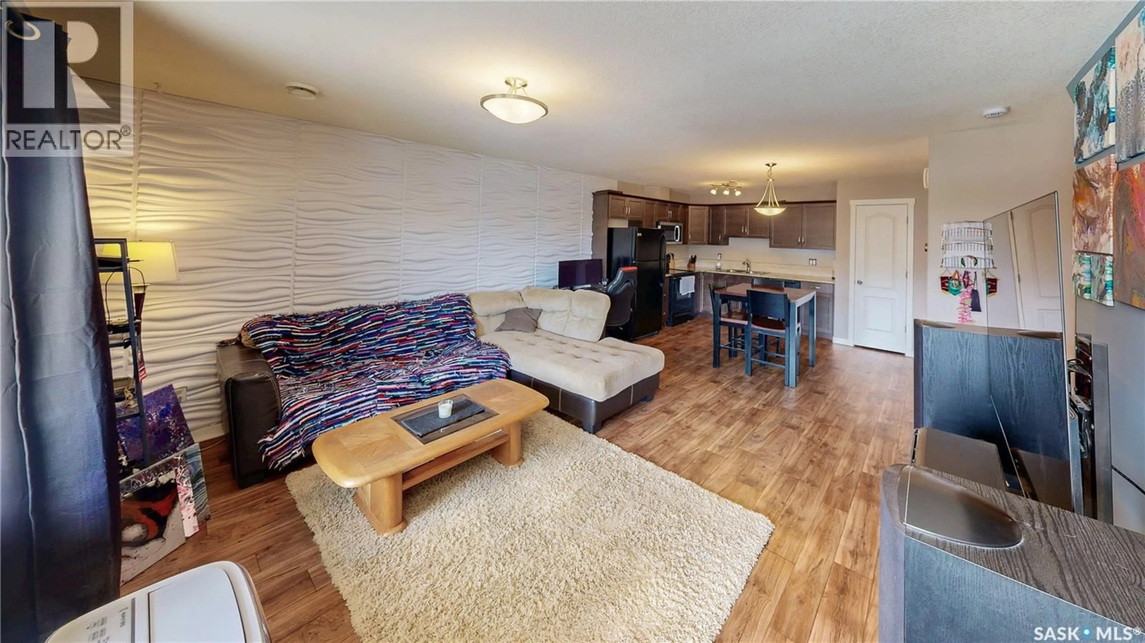 Living room with furniture, wood/laminate floor for 216 1220 EMPRESS STREET, Regina Saskatchewan S4T1G7